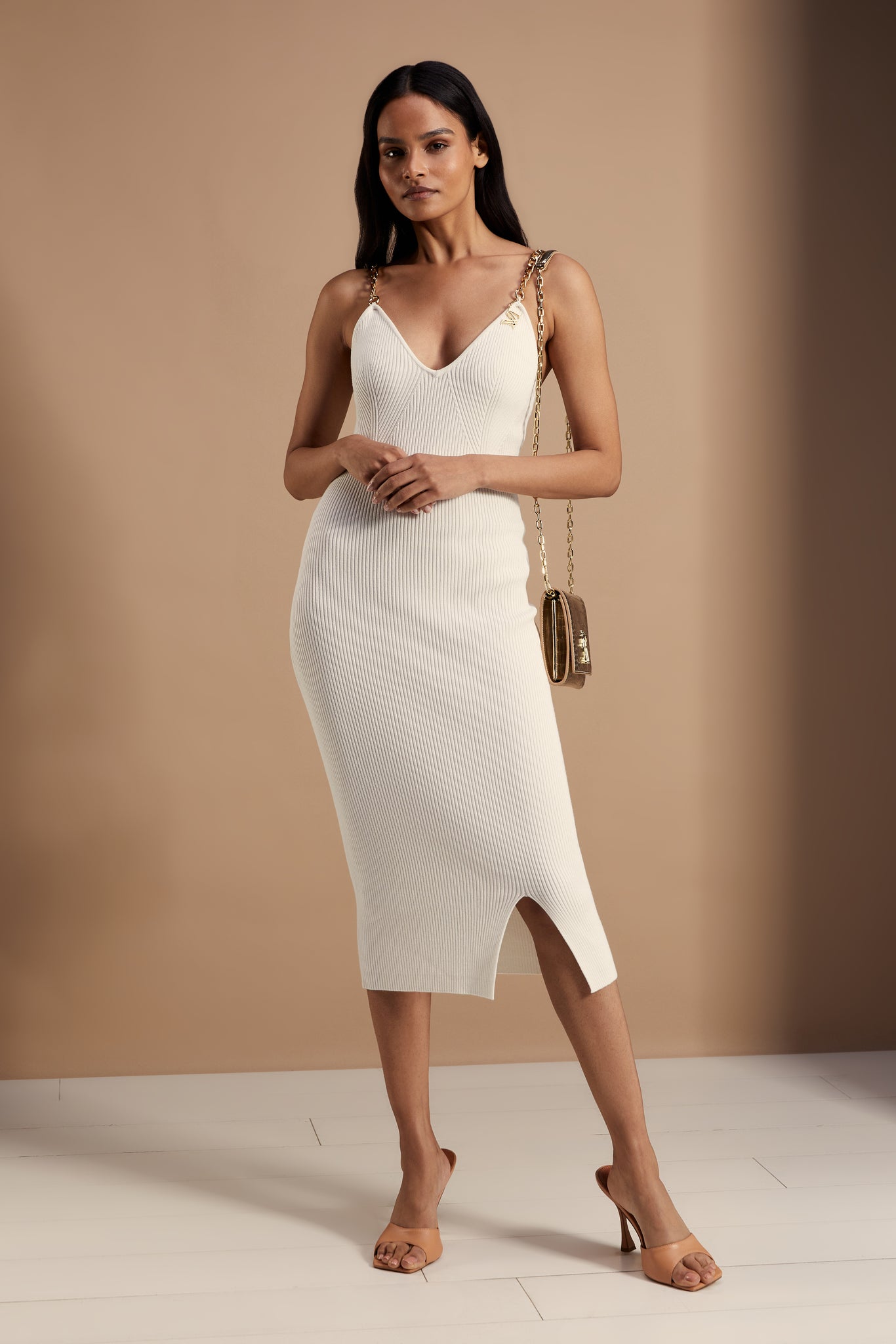 womens white ribbed v neck midi dress with gold chain straps and gold croc embossed leather clutch bag