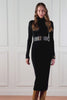 video of womens black knitted roll neck midi dress with gold buttons on cuffs and shoulders 