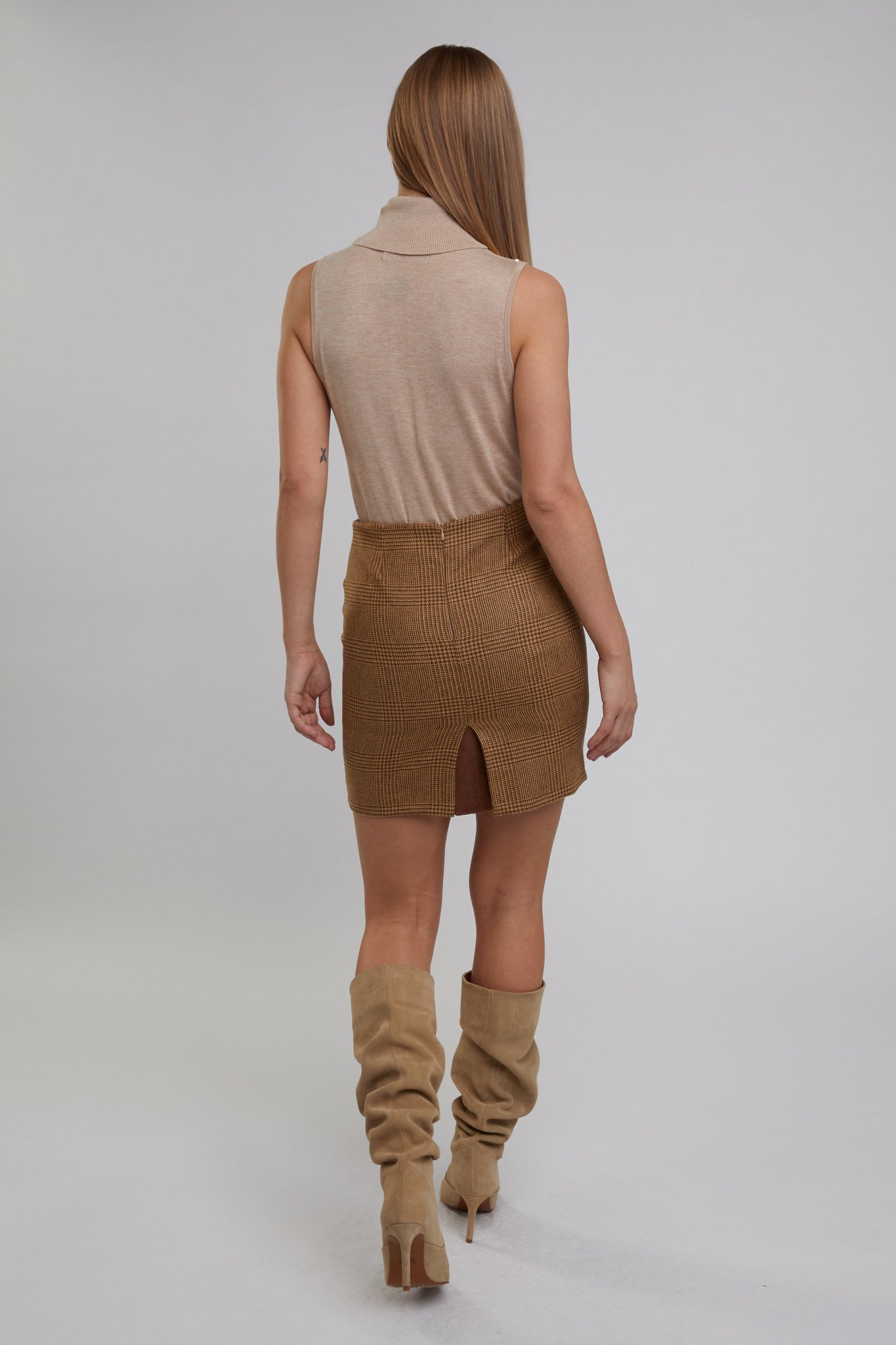 back of womens wool pencil mini skirt in light brown check tweed with slit on back and zip fastening on centre back