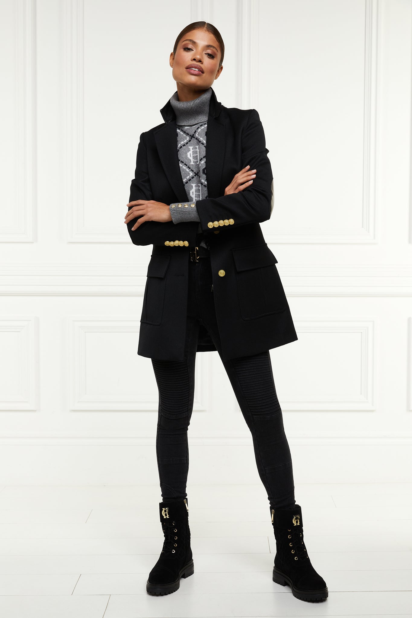 relaxed fit single breasted blazer breasted blazer in black with patch pockets and tonal black leather elbow patches and collar worn with grey monogram roll neck jumper black skinny jeans and black biker boots