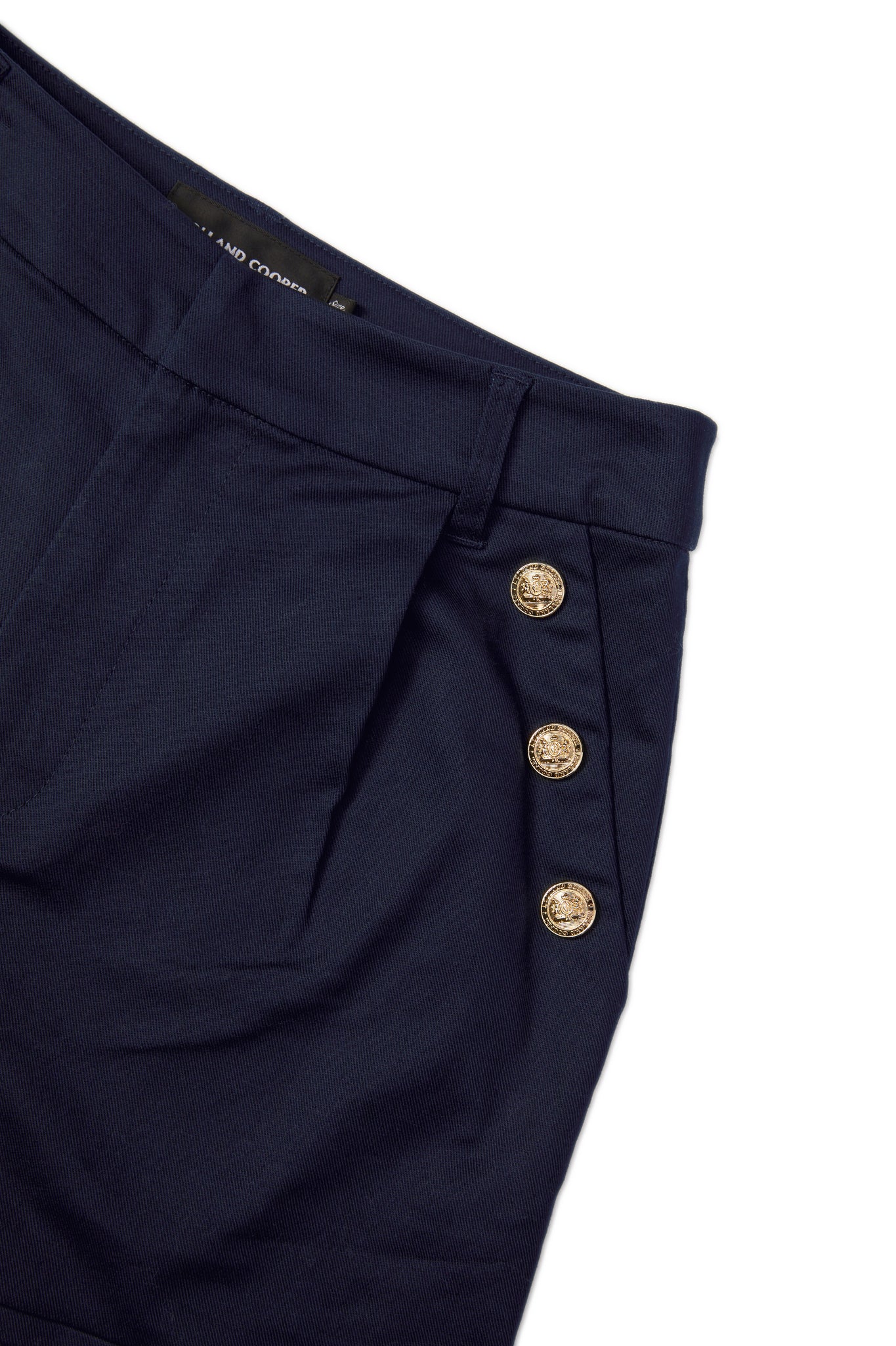 gold rivet pocket detail on womens navy high rise tailored shorts with decorative gold rivets that follow the pocket line in a sailor style with a turned up hem