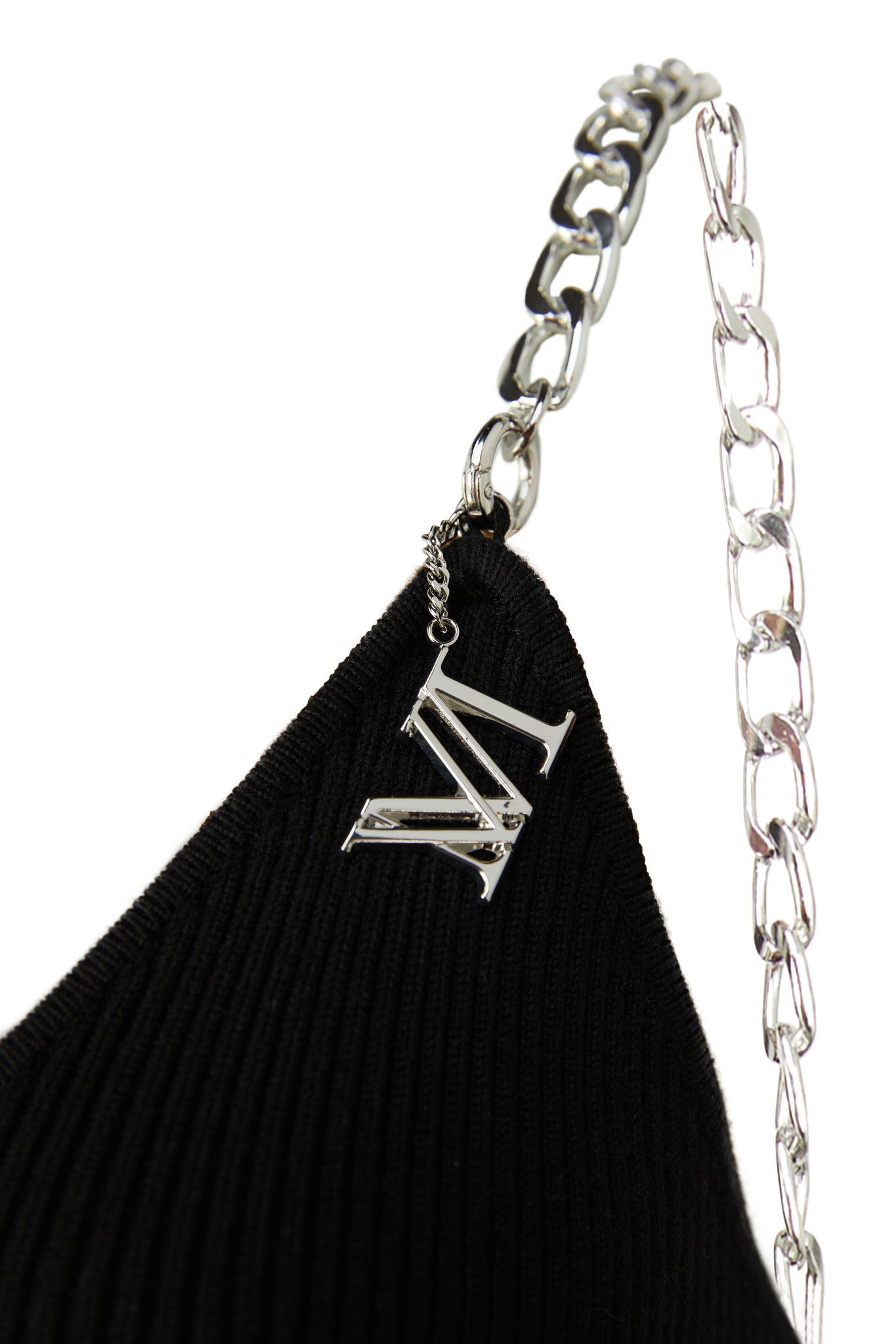 detail shot of silver chain straps on womens black ribbed v neck midi dress