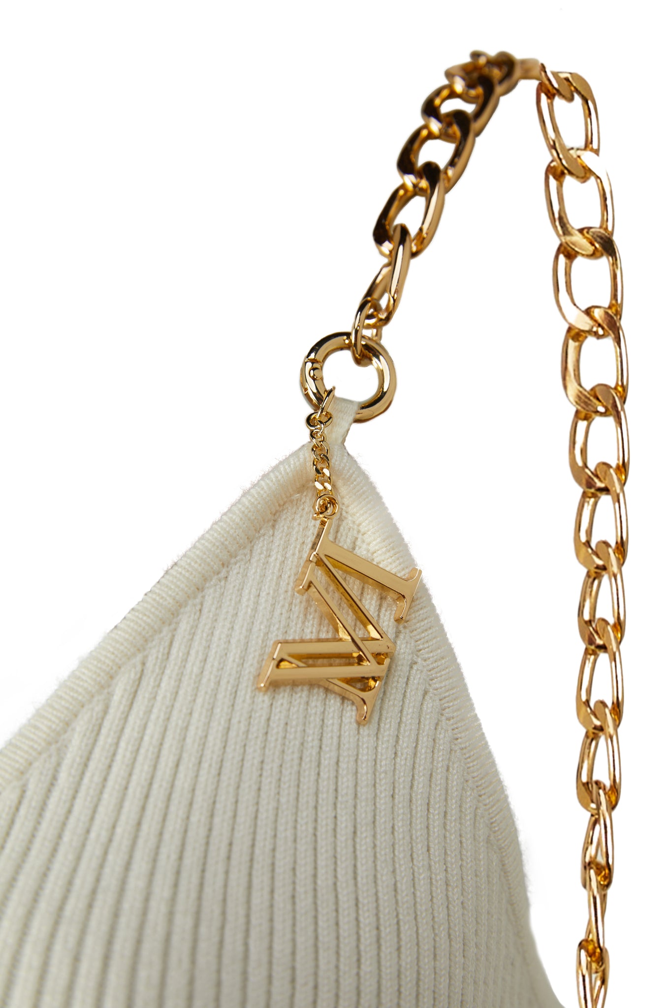 detailed shot of gold chain straps on womens white ribbed v neck midi dress 