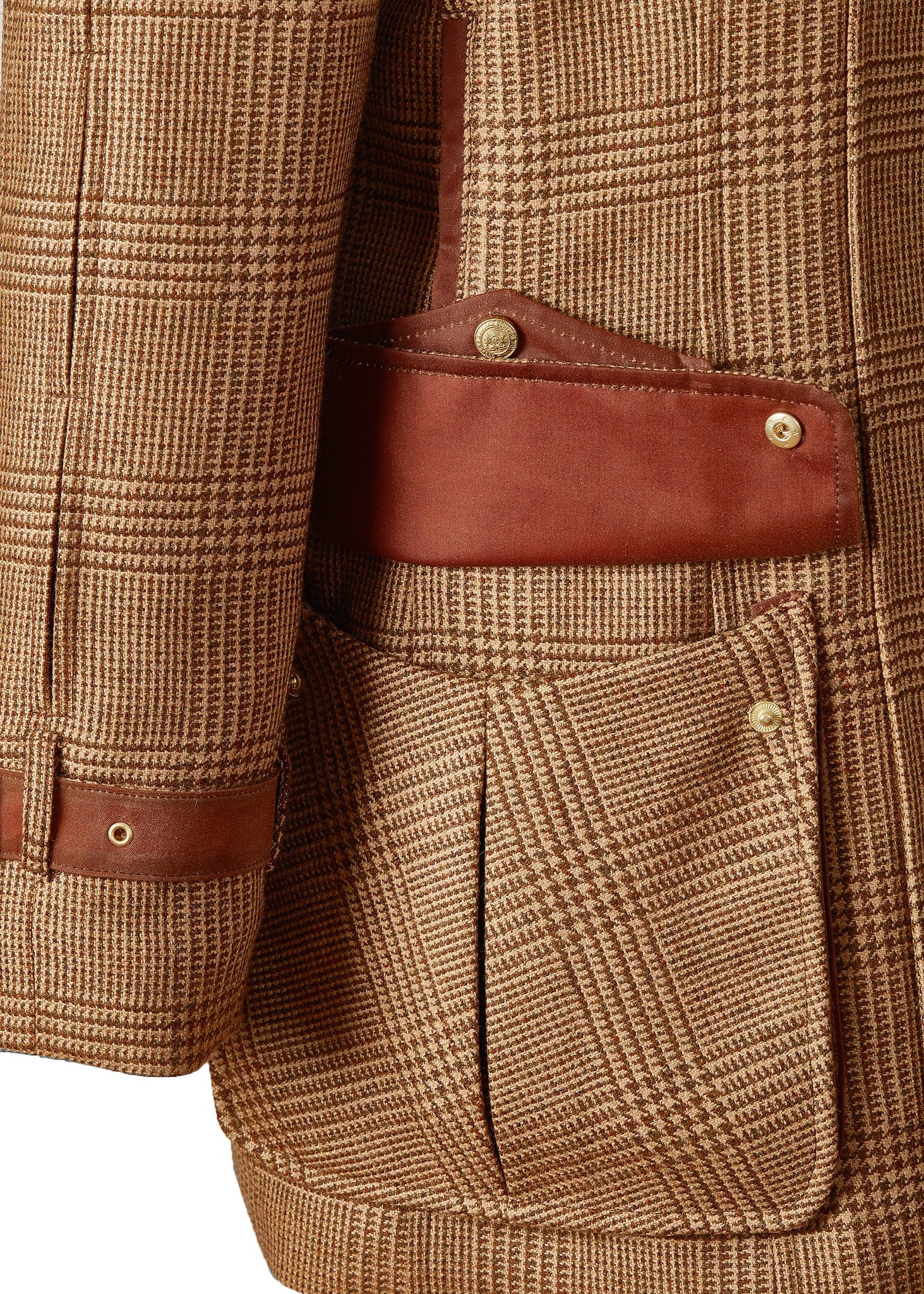 Open pocket of tan brown tartan tweed field coat