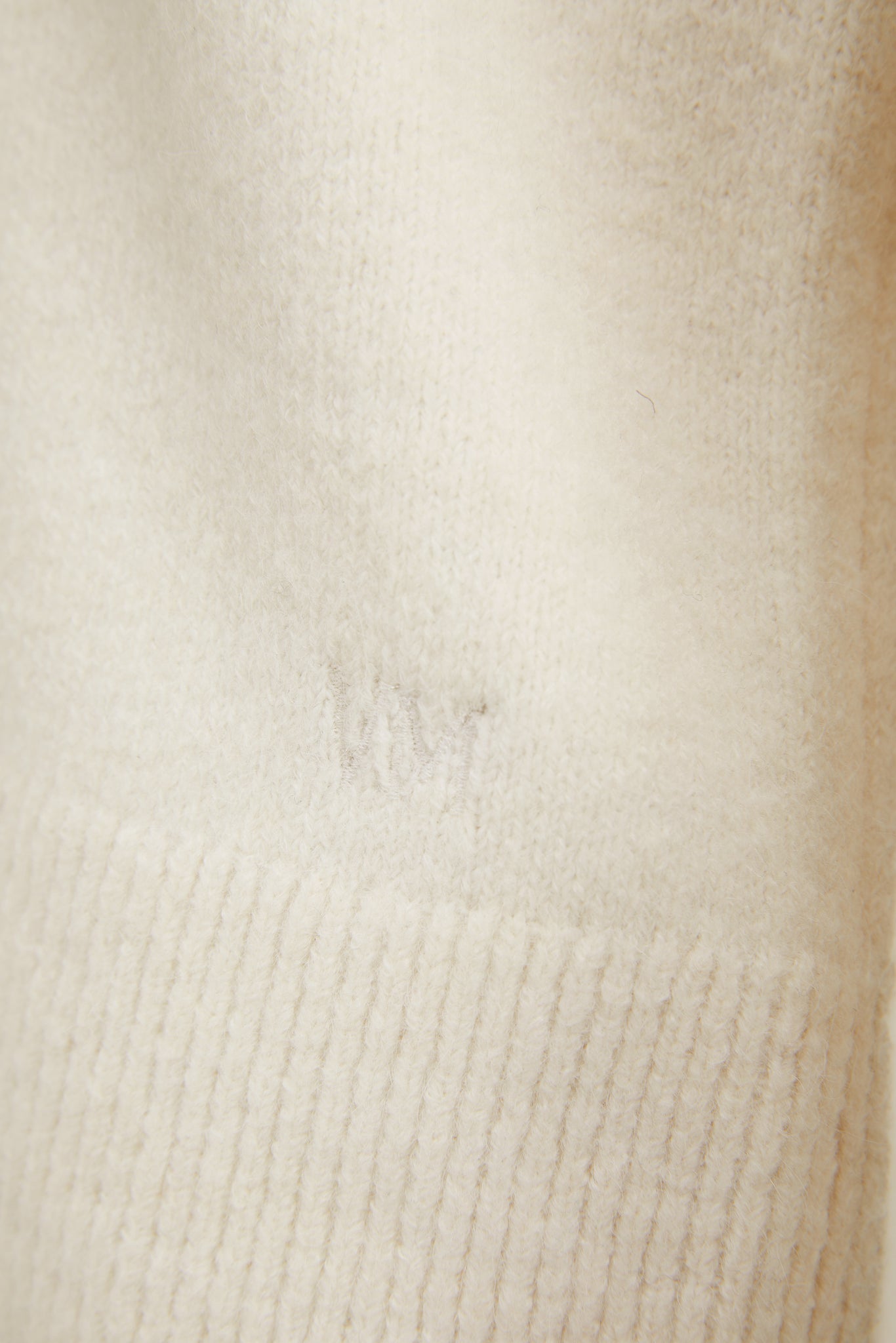 victoria magrath embroidery detail on hem of womens lightweight  v neck knit in cream with gold button cuffs