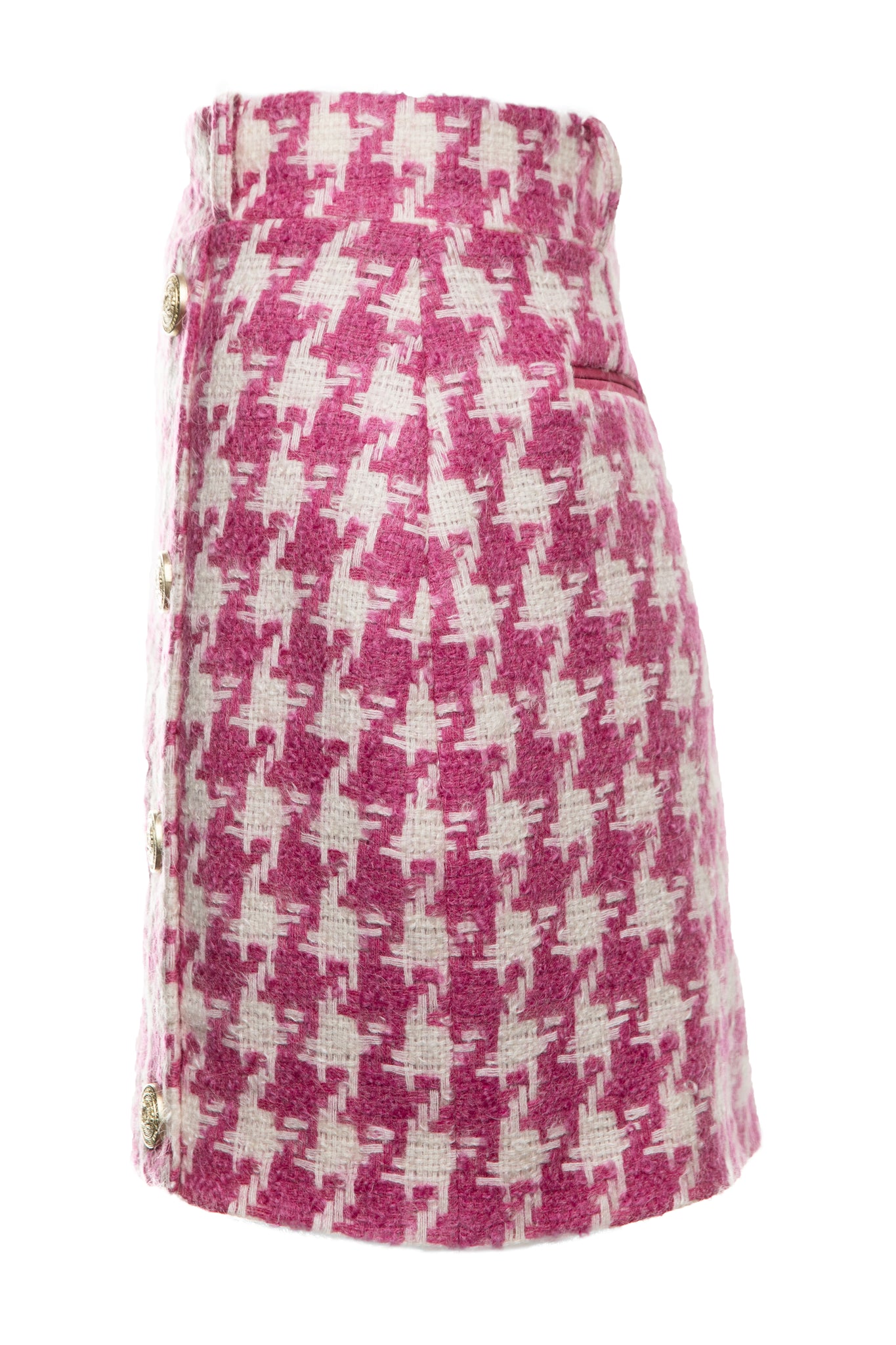 side of womens pink and white houndstooth wool pencil mini skirt with concealed zip fastening on centre back and gold rivets down front