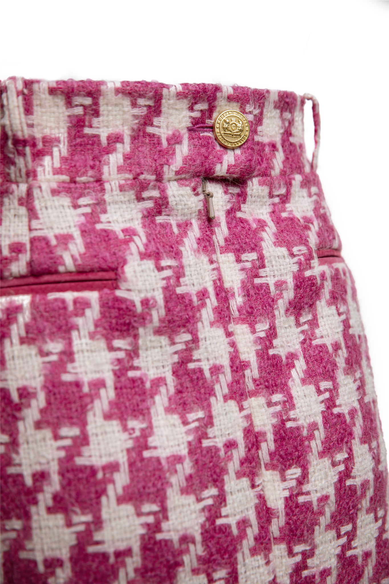 gold button detailing on back waistband of womens pink and white houndstooth wool pencil mini skirt with concealed zip fastening on centre back and gold rivets down front
