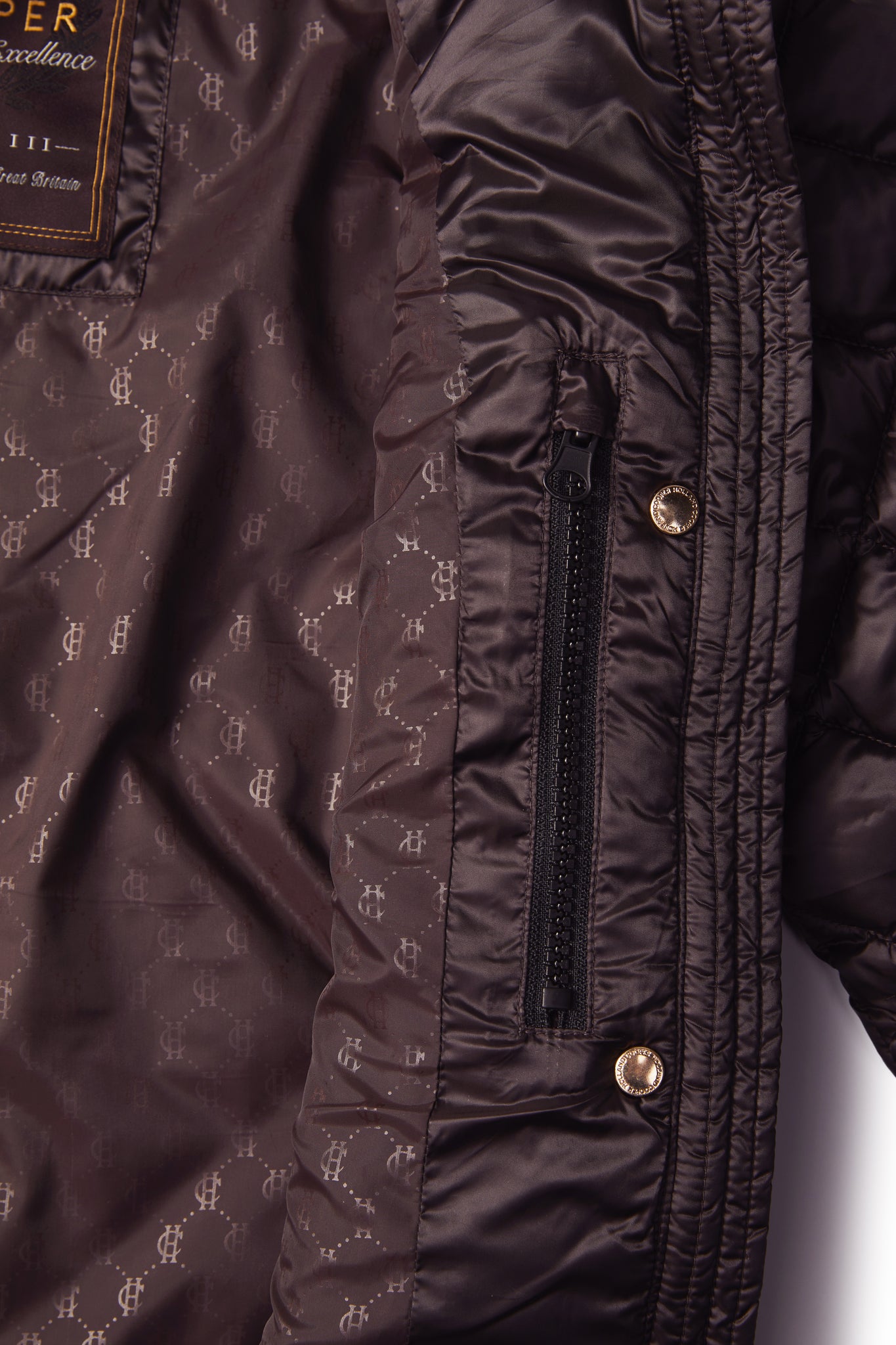 inside pocket detail on womens diamond quilted chocolate jacket with contrast tan leather elbow and shoulder pads large front pockets and shirred side panels
