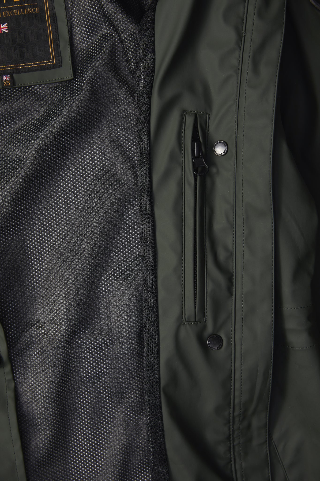 detail of womens green hooded rain coat with black hardware 