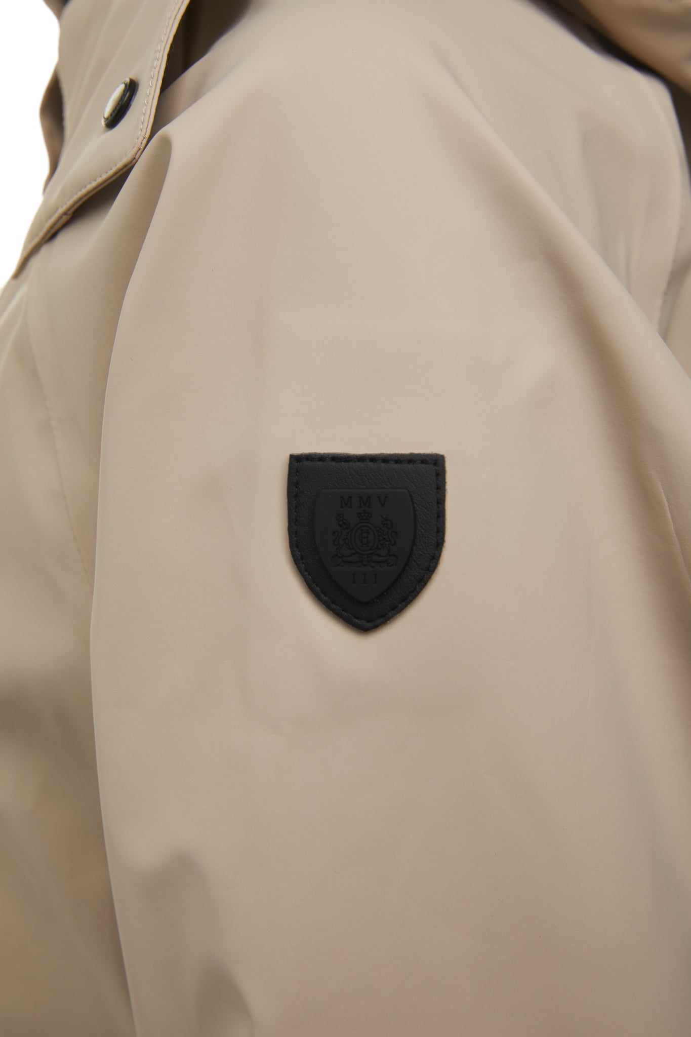 black shield detail of womens stone rain coat with hood 
