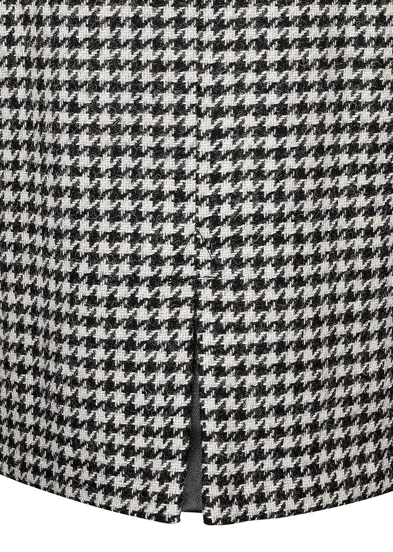 slit detail of womens black and white houndstooth tweed wool pencil mini skirt in with slit on back and zip fastening on centre back