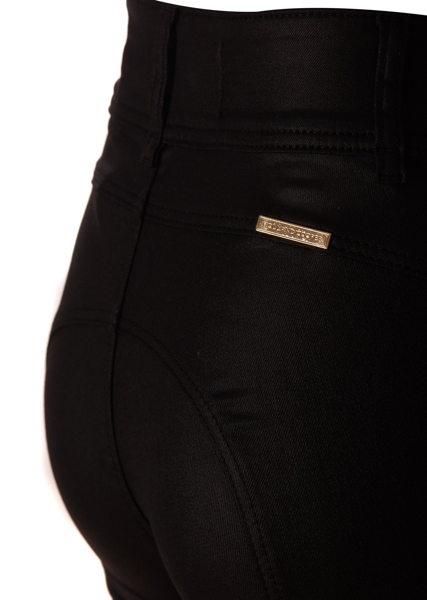 gold hardware on back of womens high rise black coated skinny jean for a waxed look with jodhpur style seams and two open zip pockets to the front with HC branded pulls