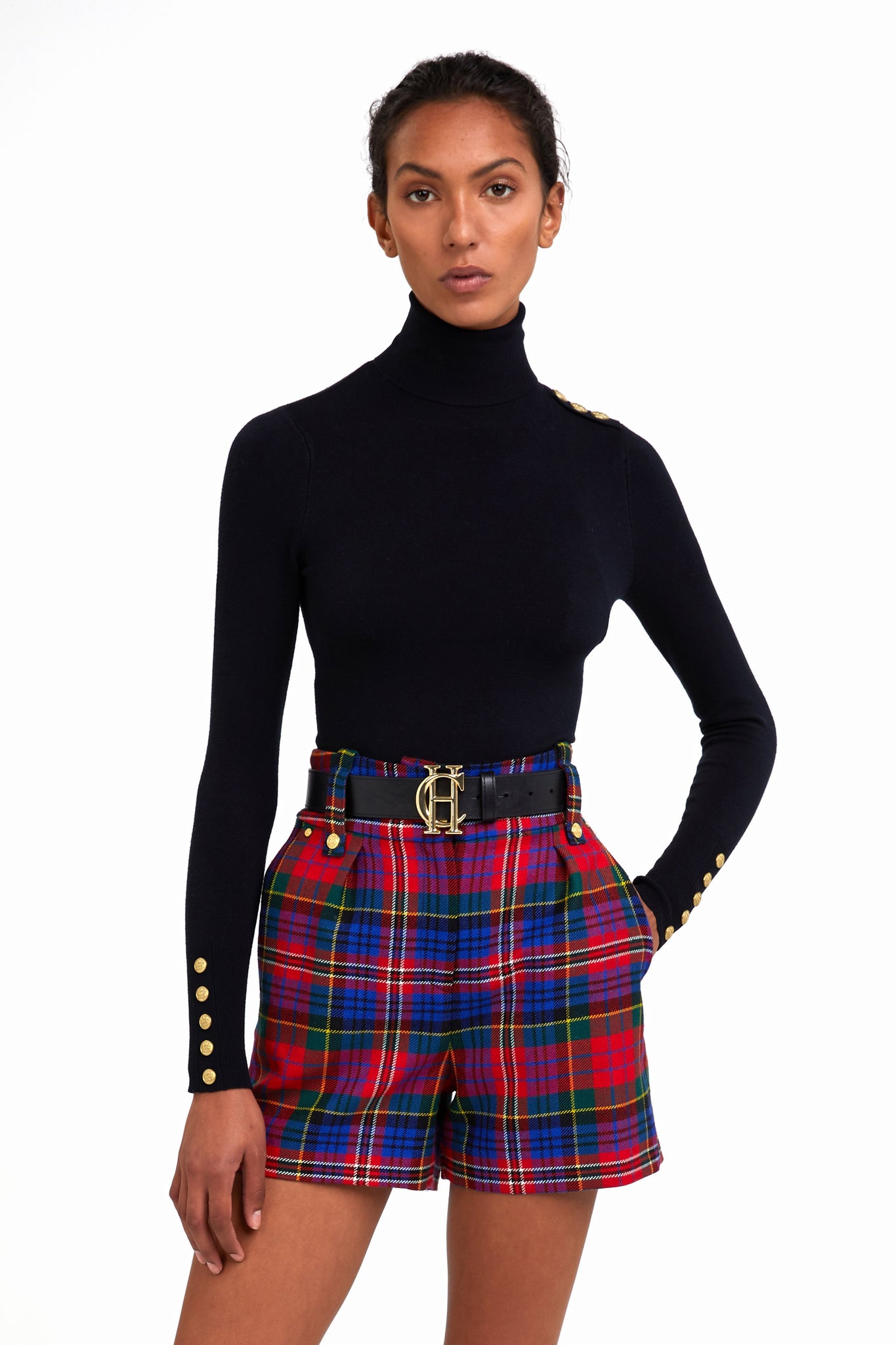womens red blue and green tartan high rise tailored shorts with two single knife pleats and centre front zip fly fastening with twin branded gold stud buttons and side hip pockets with branded rivet detailing at top and bottom of pockets worn with black roll neck