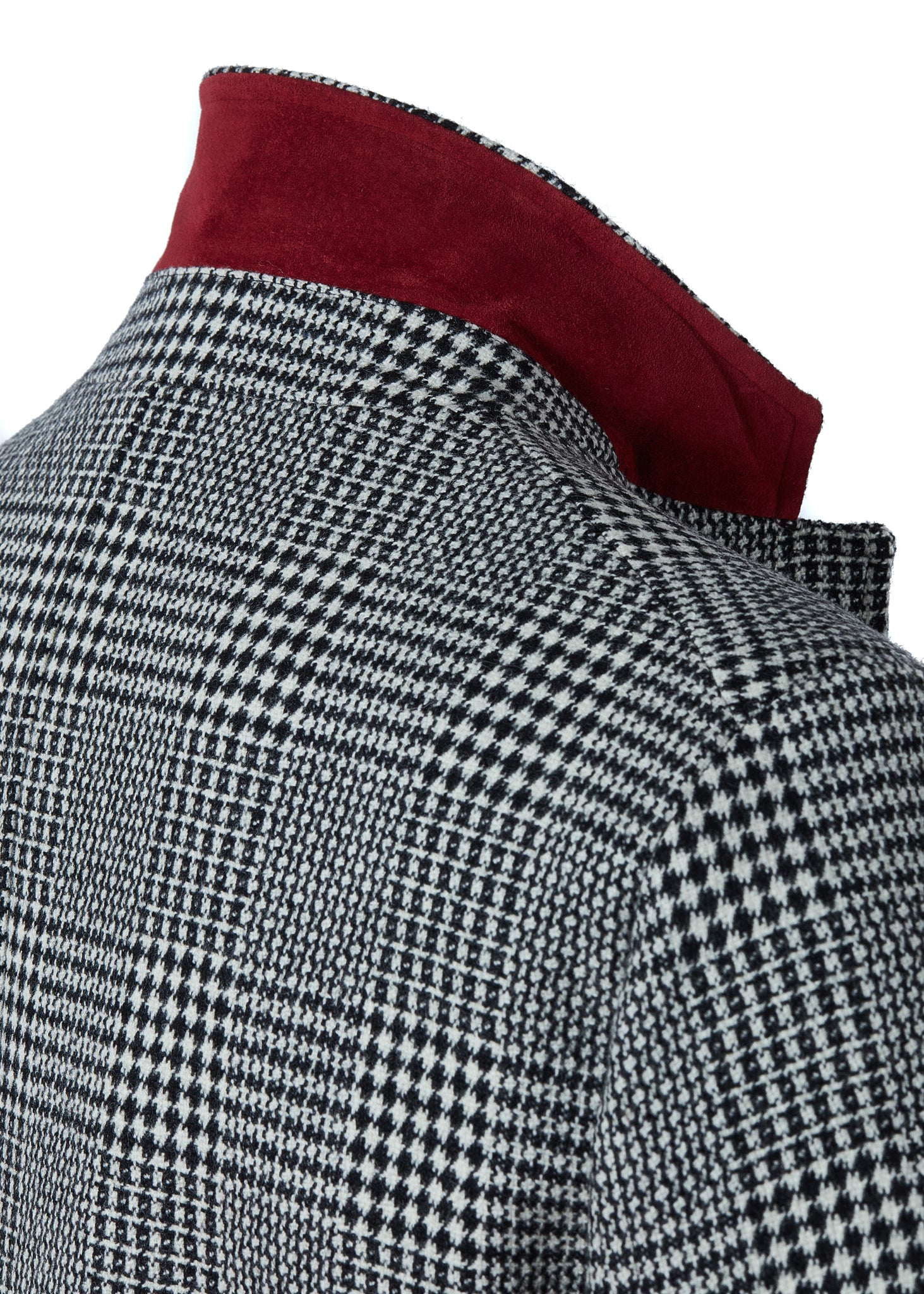 Black and white tweed mens coat with collar popped to show red under collar