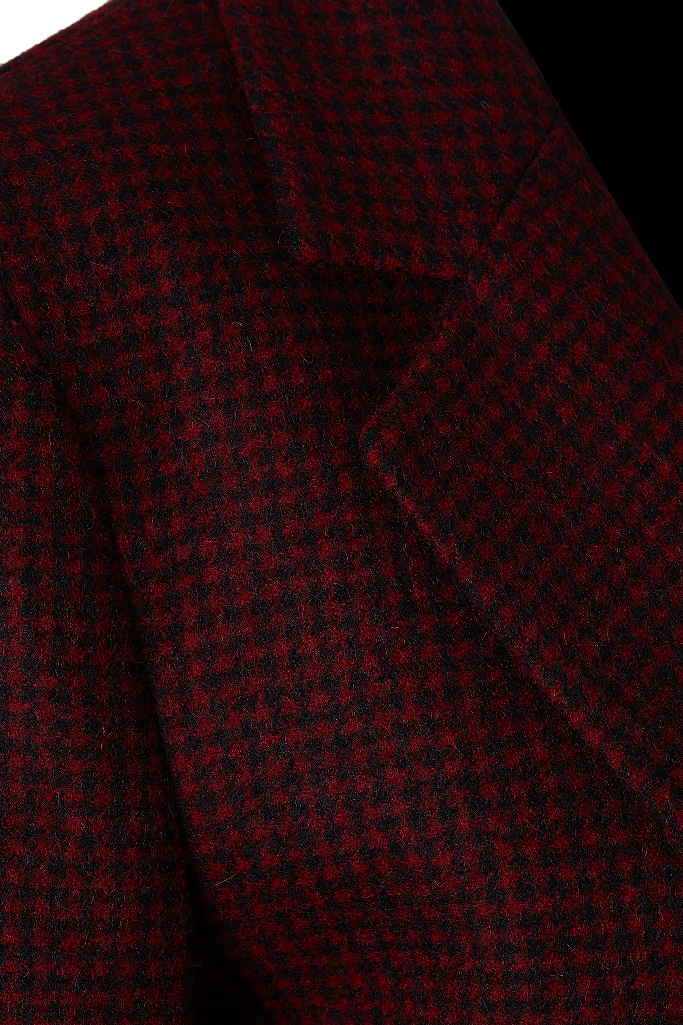 lapel detail on double breasted wool blazer in deep red houndstooth with two hip pockets and gold button detials down front and on cuffs and handmade in the uk