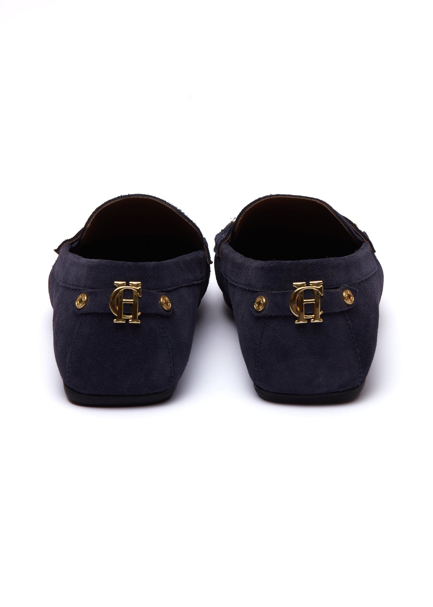 back of navy suede loafers with a leather sole and gold hardware