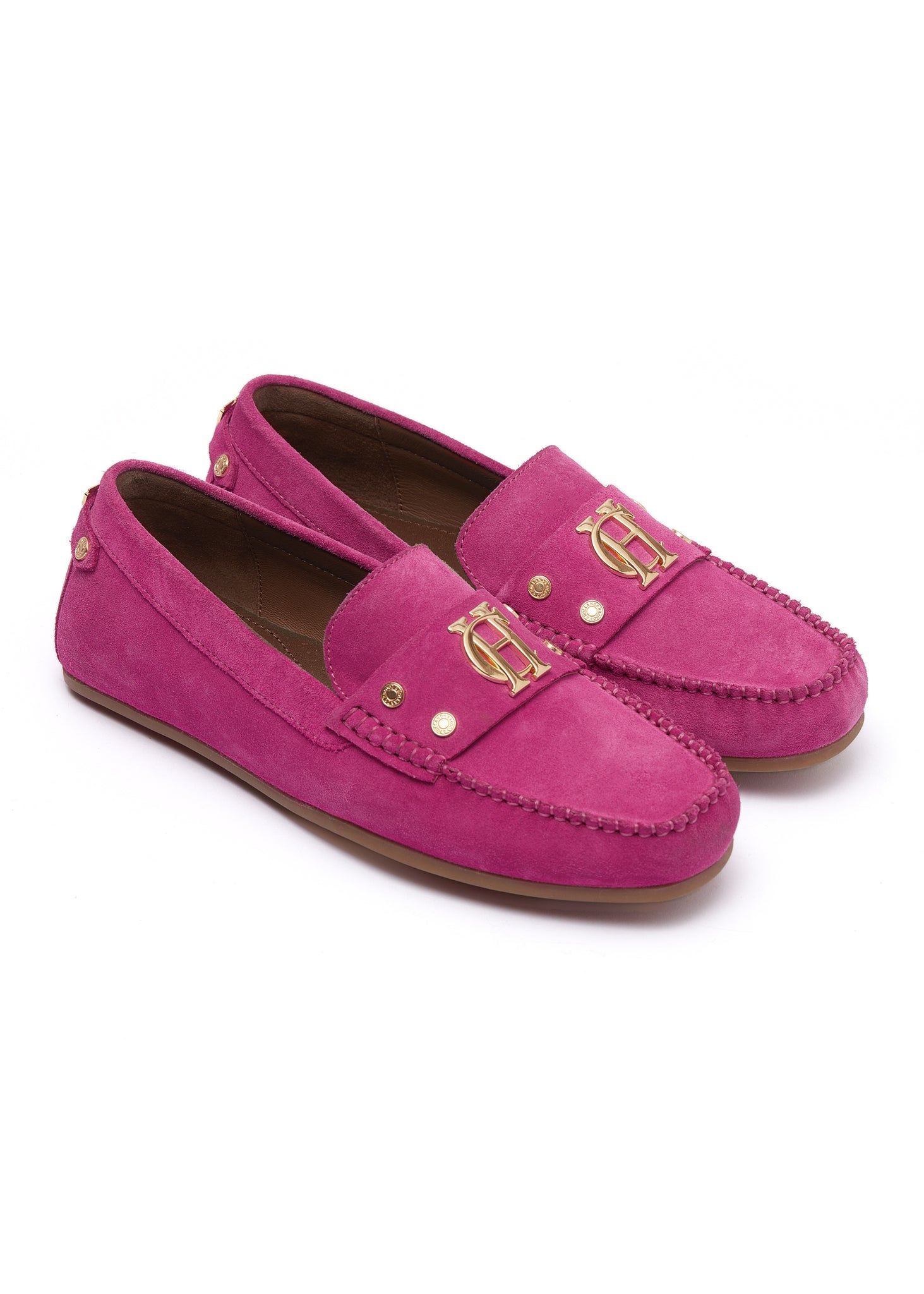 bright pink suede loafers with a leather sole and top stitching details and gold hardware