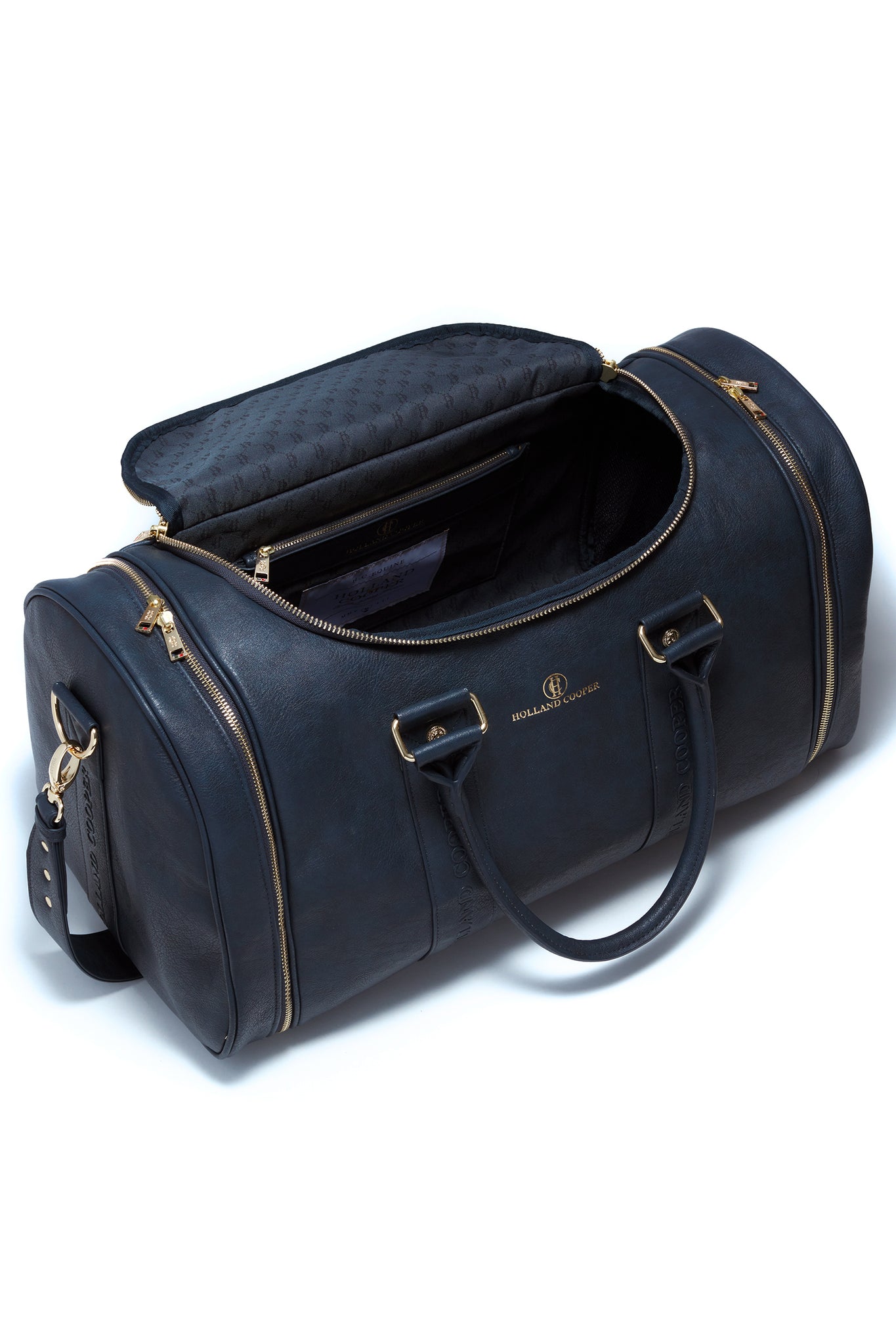 inside navy faux leather equestrian kit bag showing the navy monogram lining and internal zip pocket