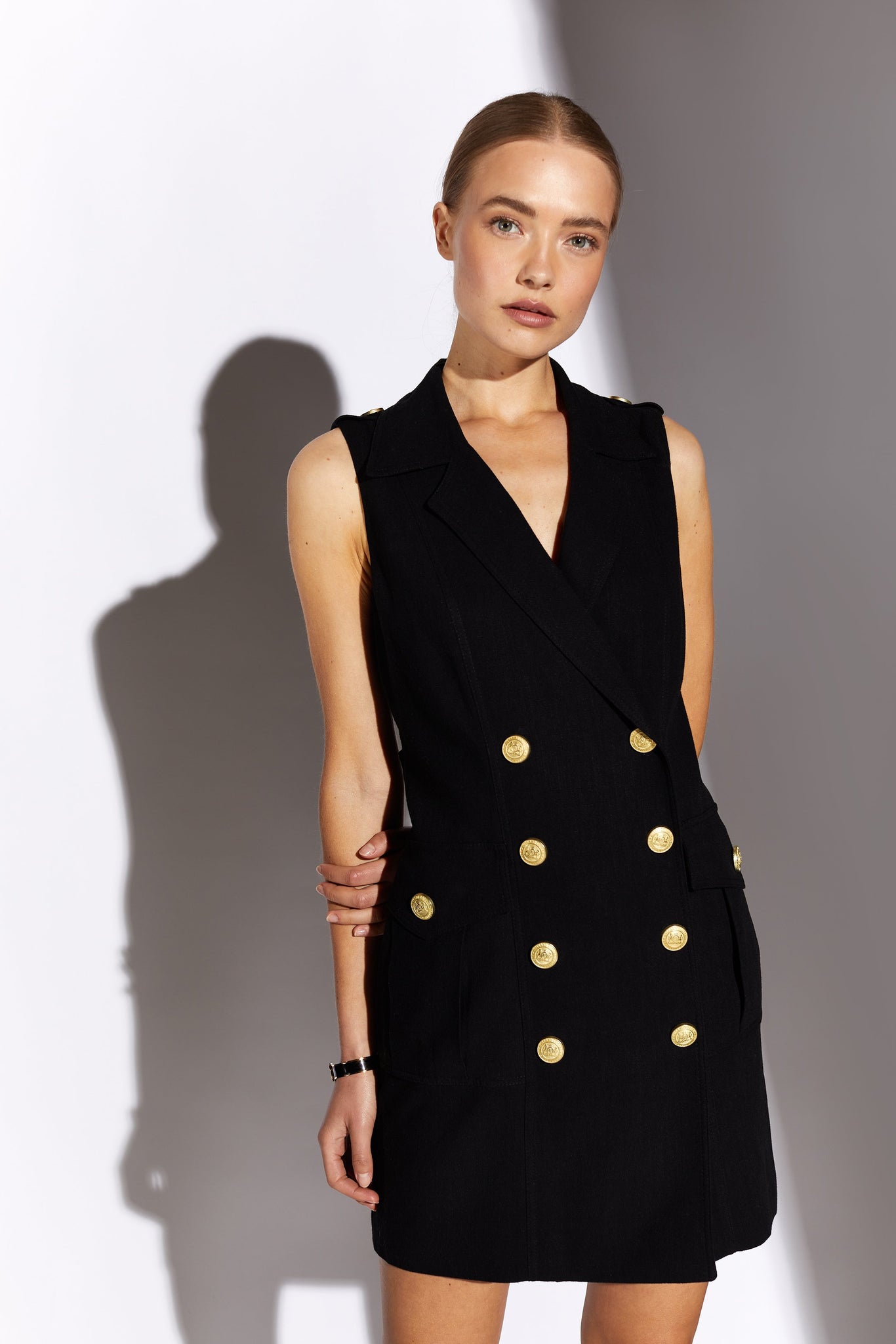 womens black linen sleeveless collared mini dress with gold button front fastening 