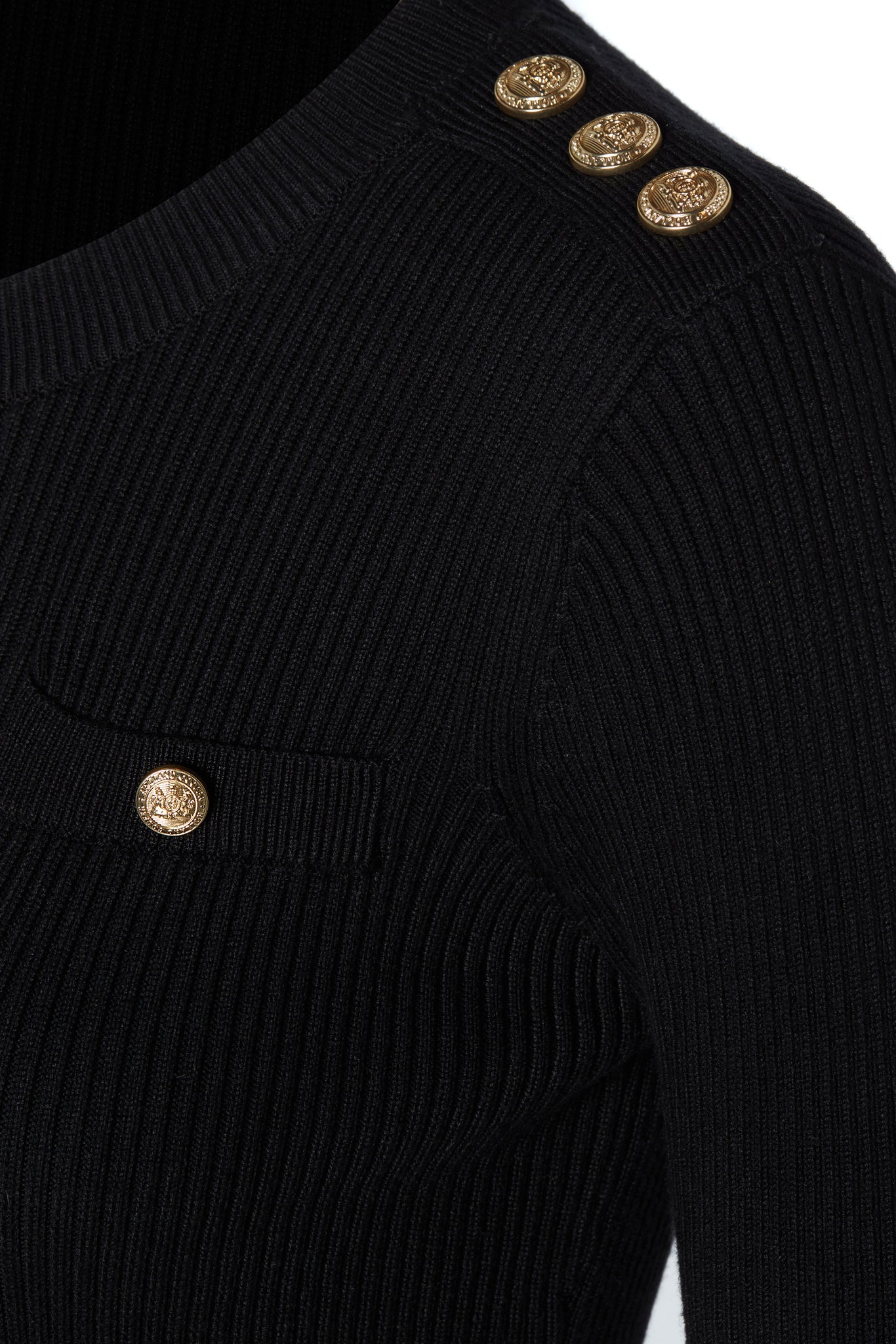 gold button detail across shoulder of womens slim fit crew neck long sleeve knitted dress in black with gold button detail down the centre front and two welt pockets on chest and two on the hips with gold buttons on the centre of each pocket