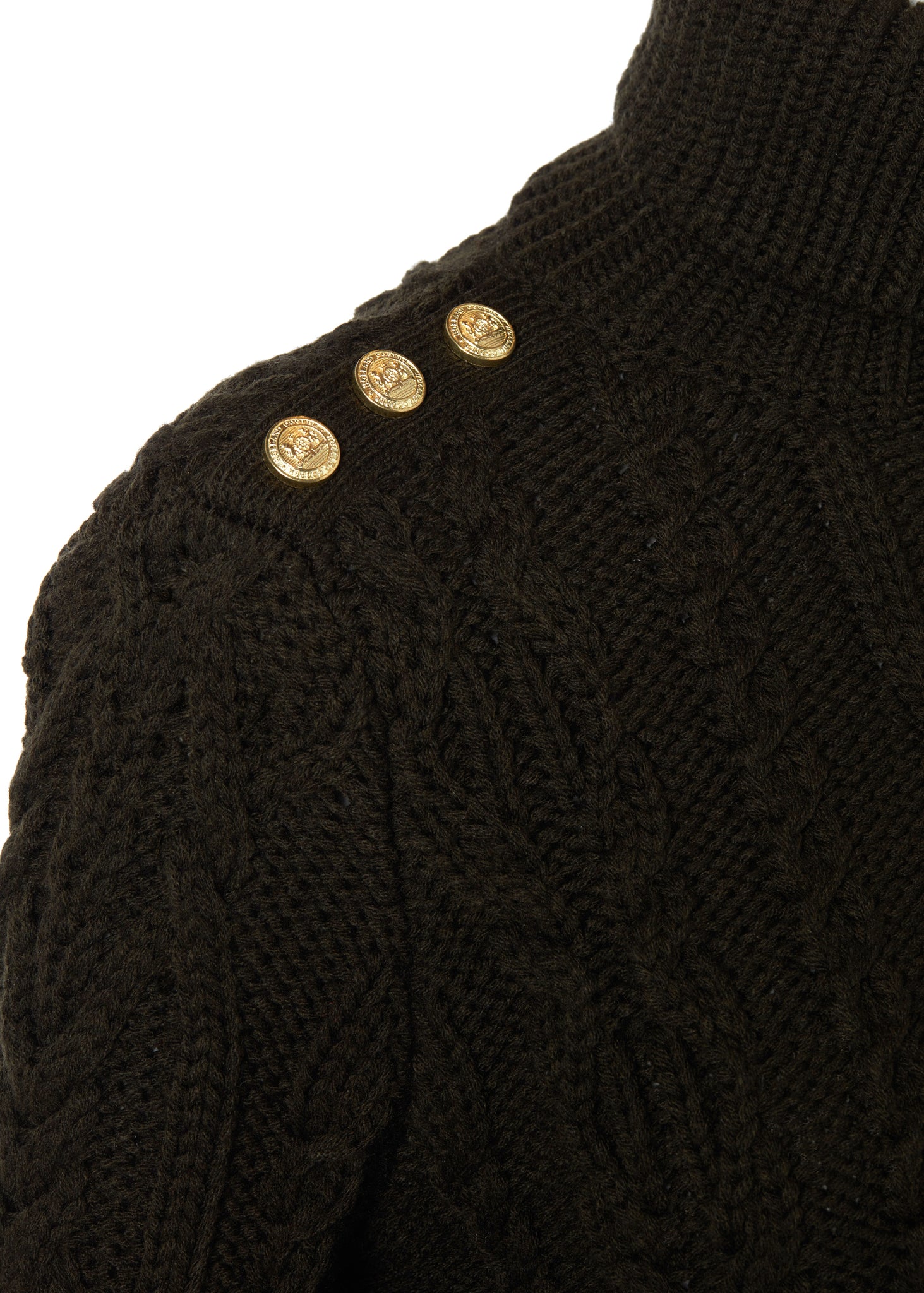 gold button detail across shoulders of a chunky cable knit roll neck jumper in fern green with dropped shoulders and thick ribbed cable trims and gold buttons on cuffs and collar