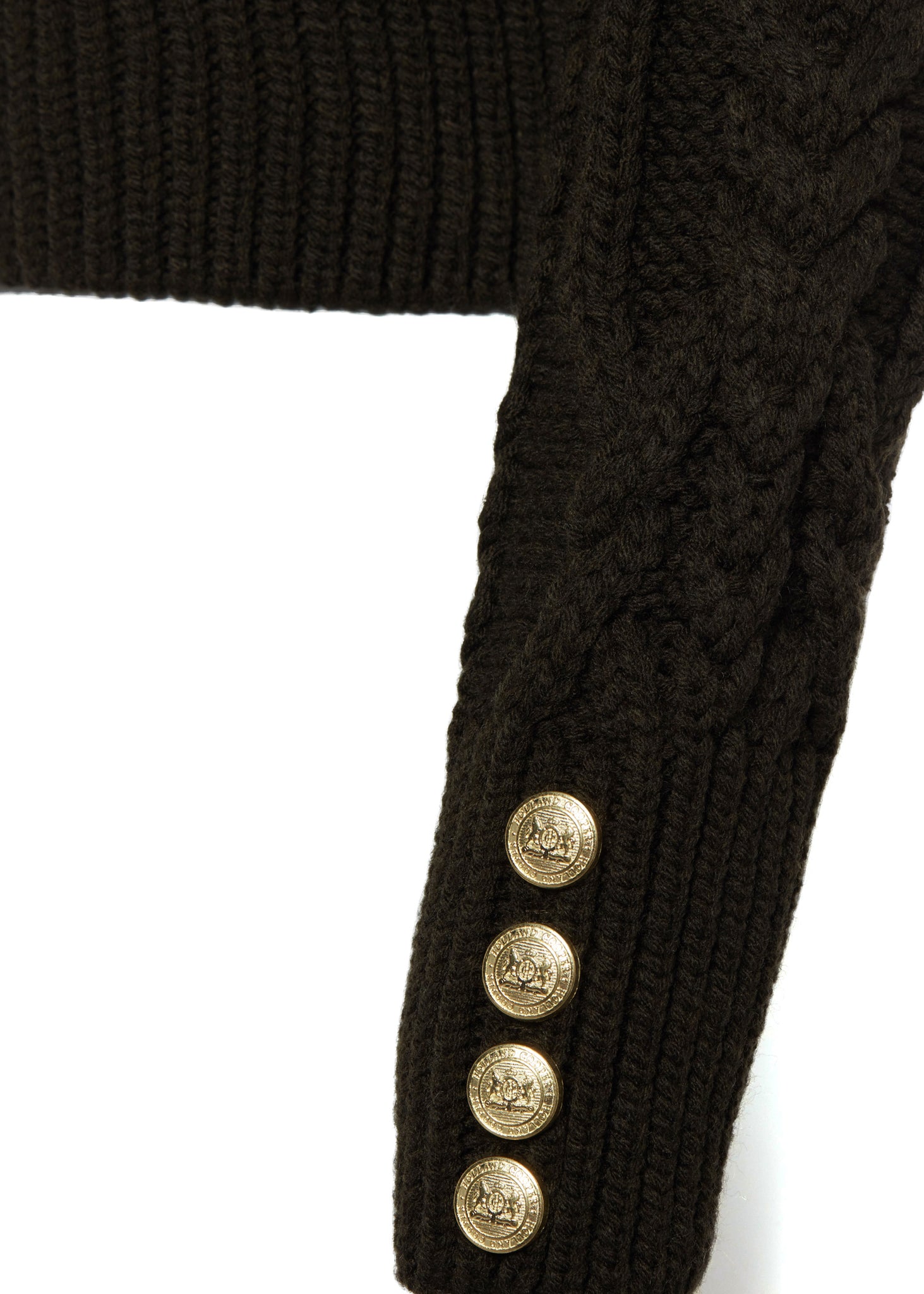 gold button detail on cuffs of a chunky cable knit roll neck jumper in fern green with dropped shoulders and thick ribbed cable trims and gold buttons on cuffs and collar