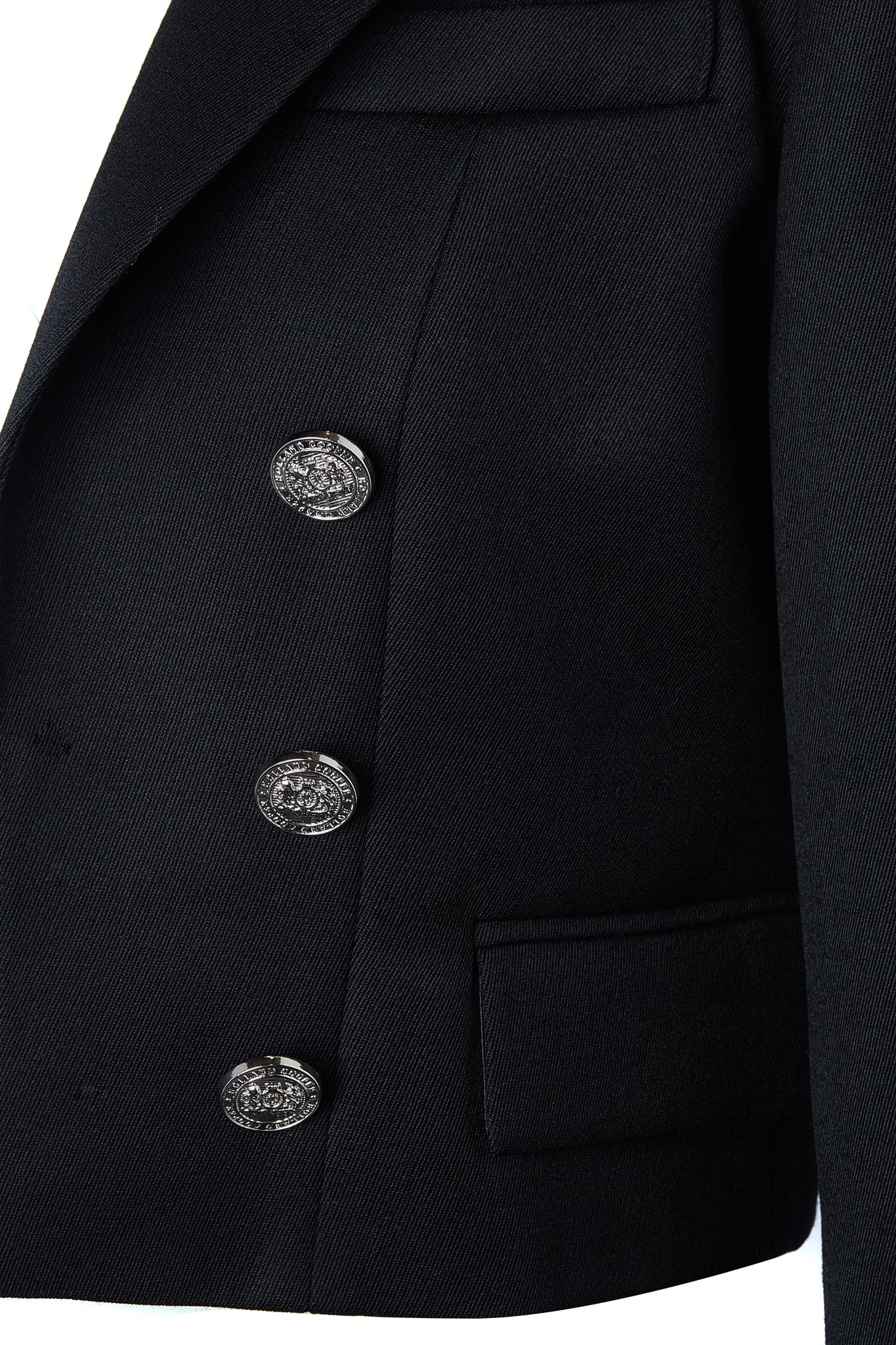 button detail on front of British made tailored cropped jacket in black with welt pockets and gold button detail down the front and on sleeves