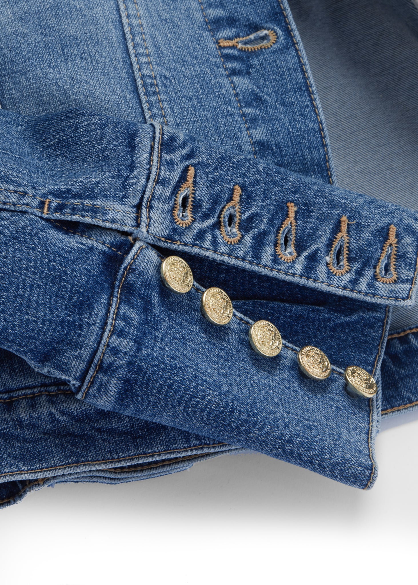 button cuff detail on classic indigo denim jacket waist length with gold buttons on front, pockets and cuffs with holland cooper embroidery on back