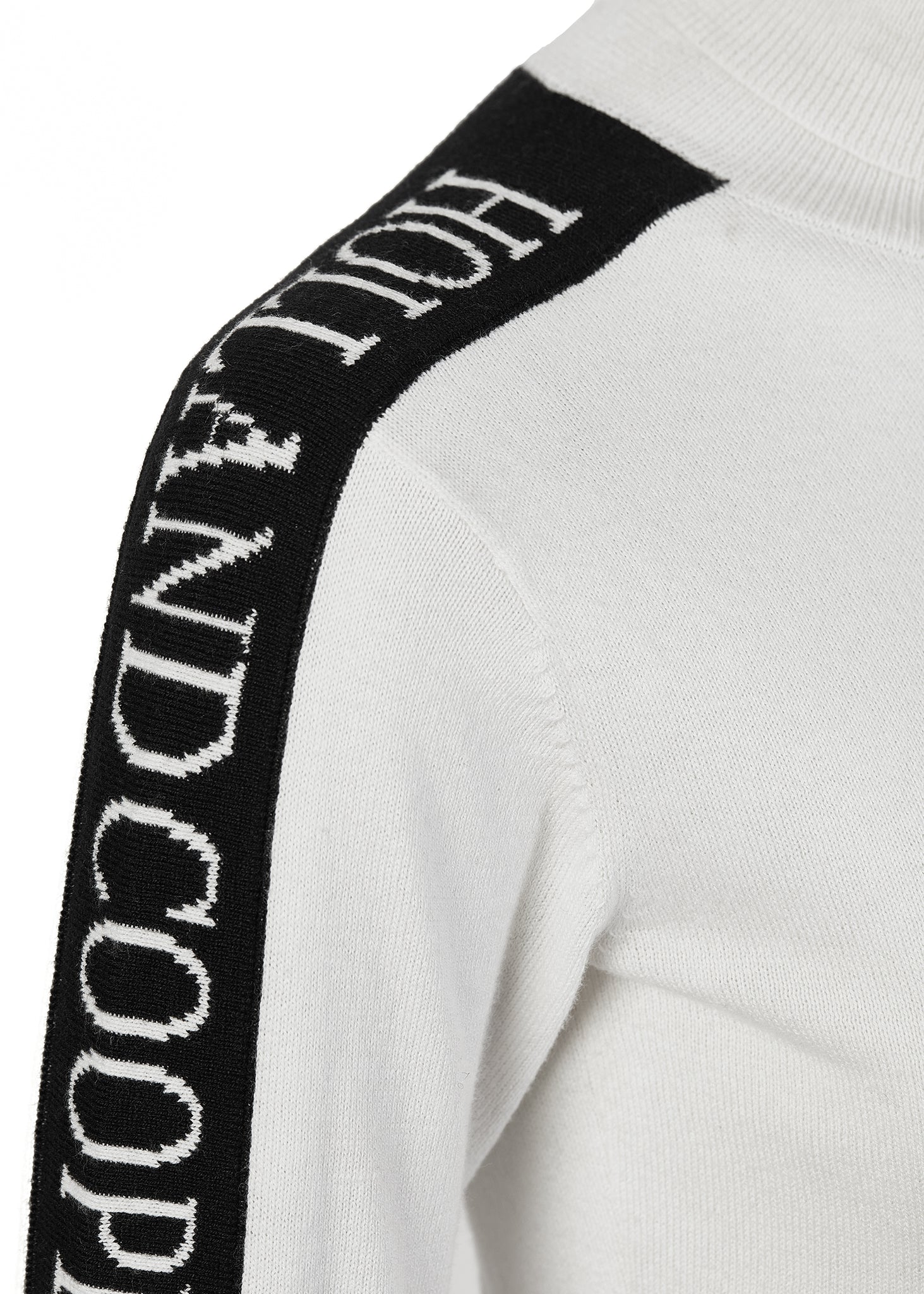 detail of black monogram intarsia knit panels down tops of arms onthermal fitted roll neck knit in white