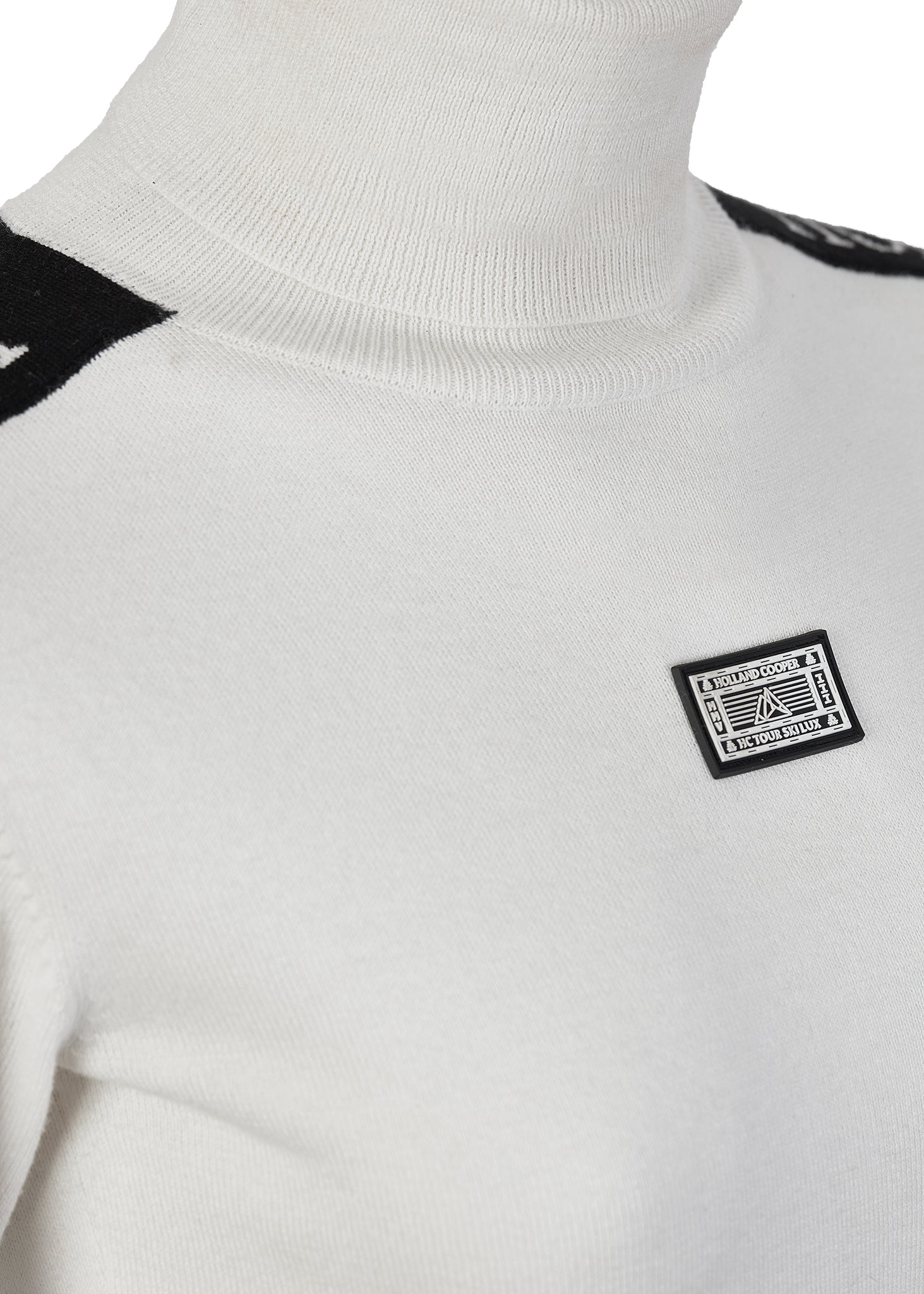 roll neck and centre front branded patch detail on thermal fitted roll neck knit in white with black monogram intarsia knit panels down tops of arms