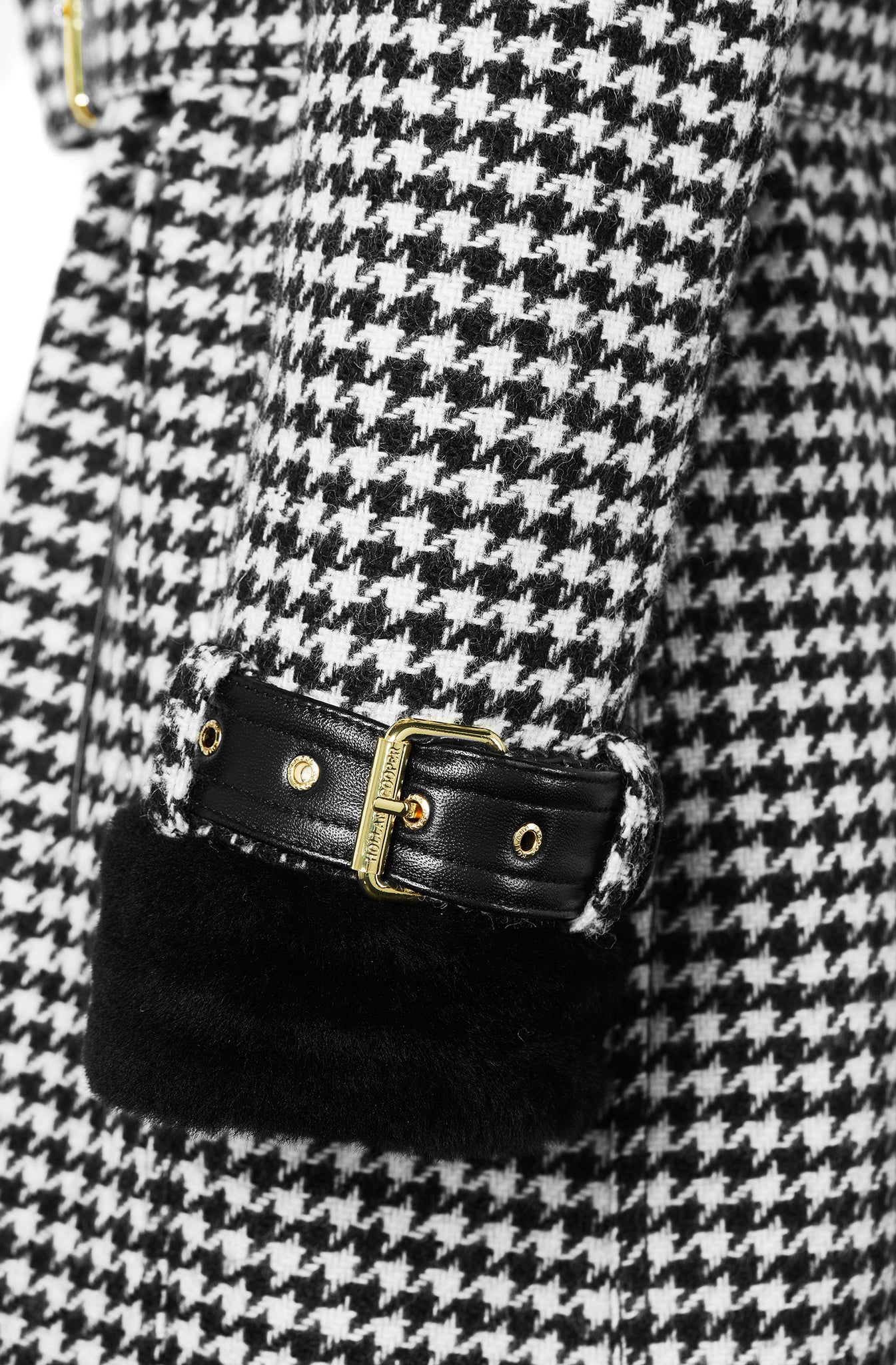 Cuff detail on womens black and white houndstooth double breasted full length trench coat with black faux fur collar and cuffs