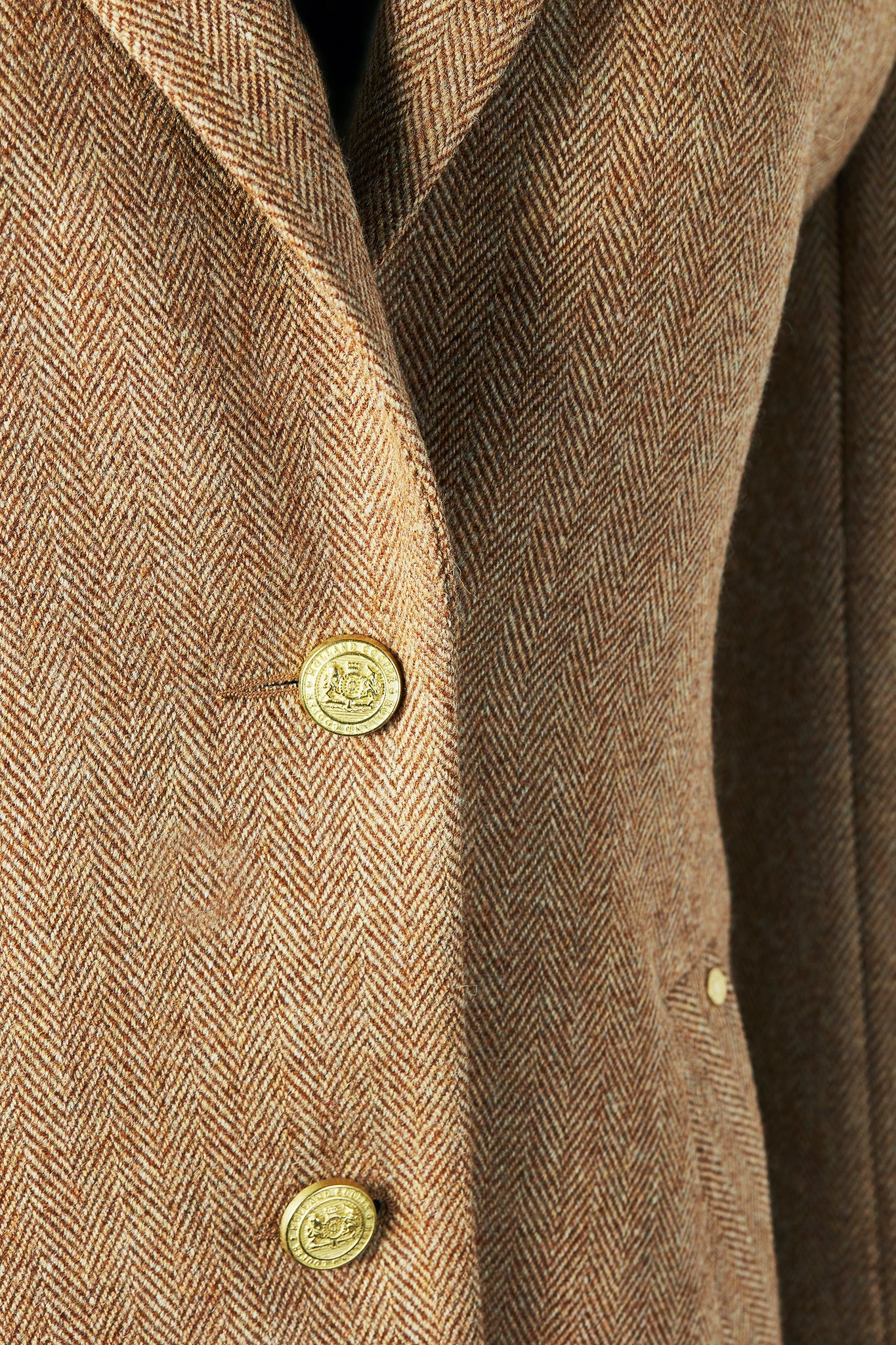 gold button detail on womens brown tweed single breasted full length wool coat