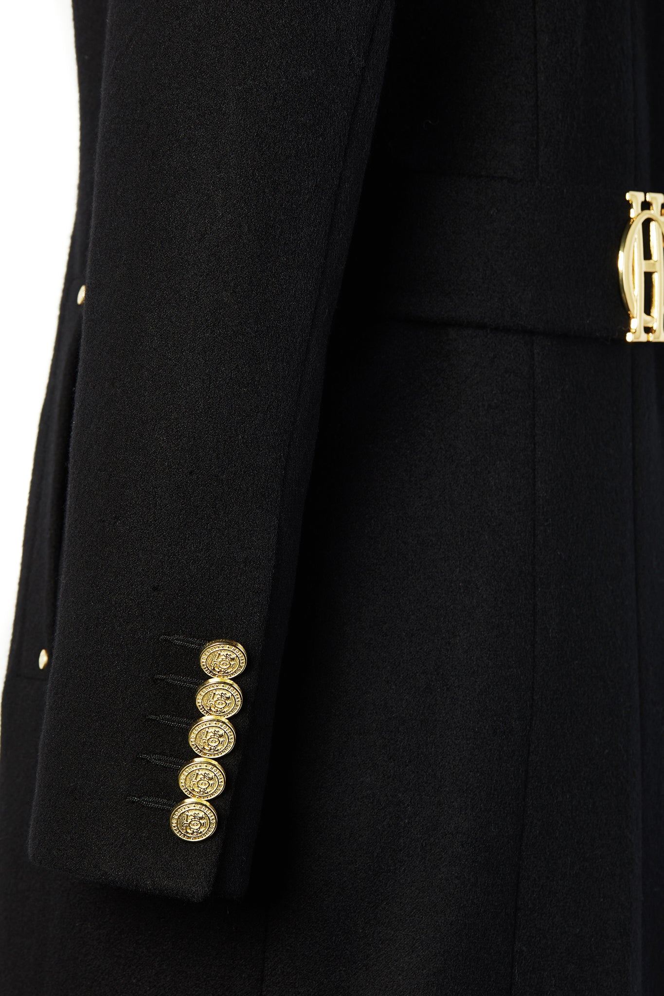 gold button sleeve detail on black single breasted full length wool coat