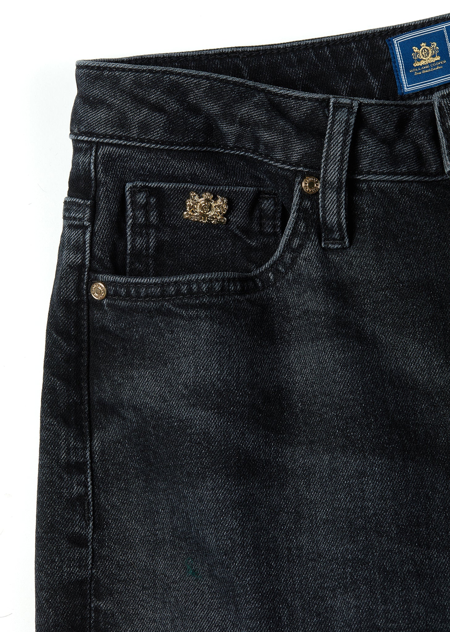 front pocket detail on womens high rise black denim slim fit jean with raw hem and two open pockets on the front and back with gold stirrup charm to the belt loop