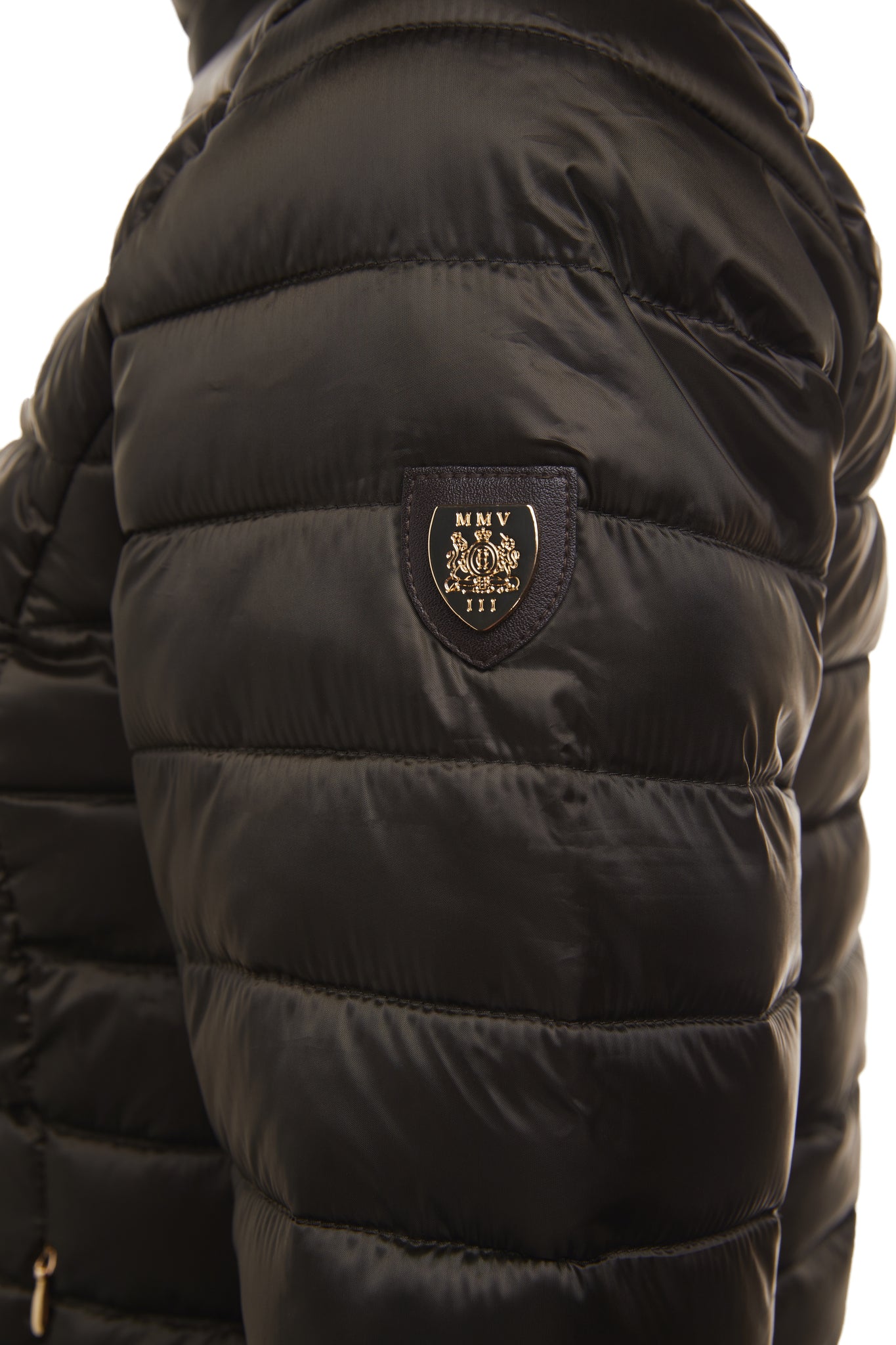 detail of gold shield badge on top of arm on womens lightweight hoodless padded khaki jacket with embroidery detail on back high neck and elasticated cuffs and hem. easily packs away into separate small bag of the same colour with handle 
