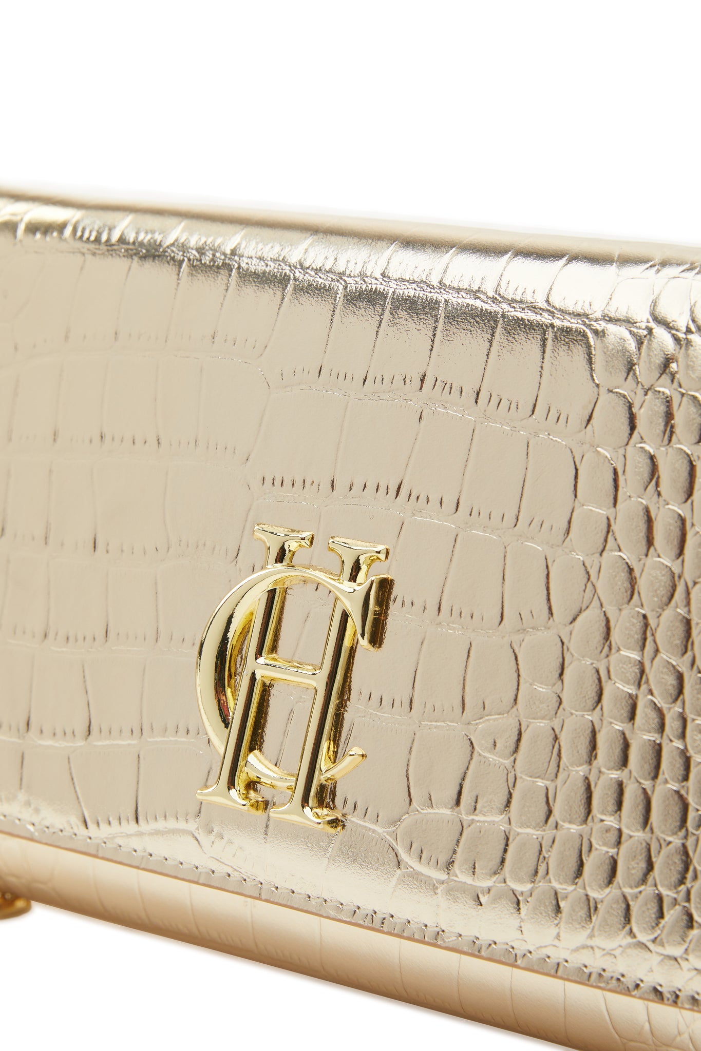 detail shot womens gold croc embossed leather clutch bag with gold hardware