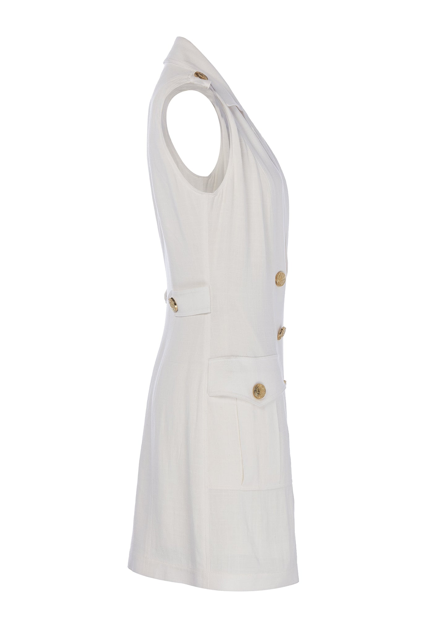 side shot of womens white linen sleeveless collared mini dress with gold button front fastening 