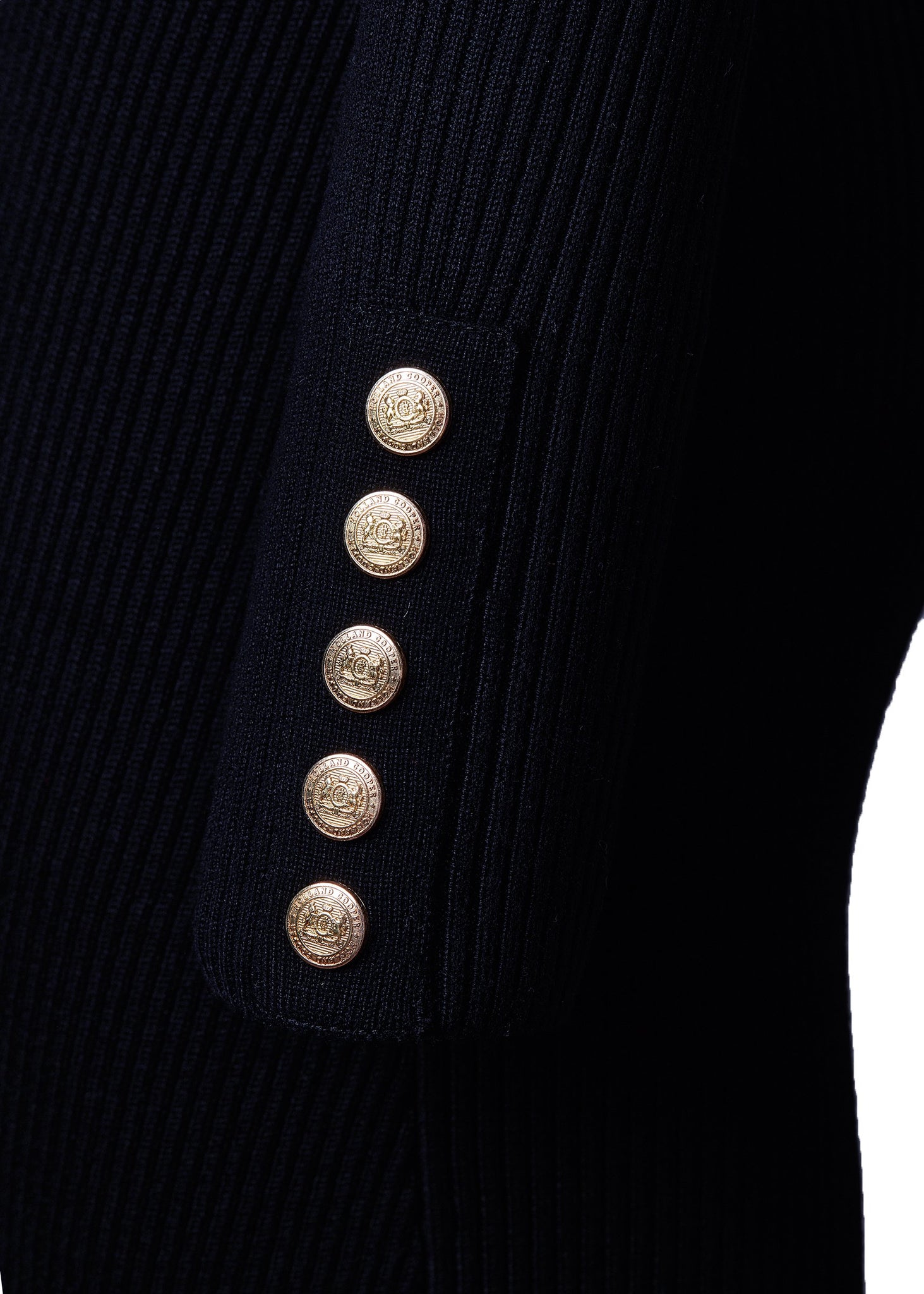 gold button cuff detail of womens body-contouring navy knitted midi dress with ribbed roll neck and cuffs and gold buttons on shoulders and cuffs