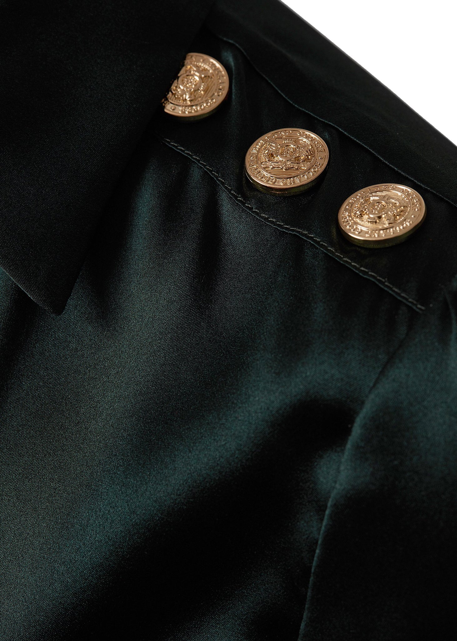 gold button shoulder detail on womens long sleeve dark green silk v neck blouse with gold buttons