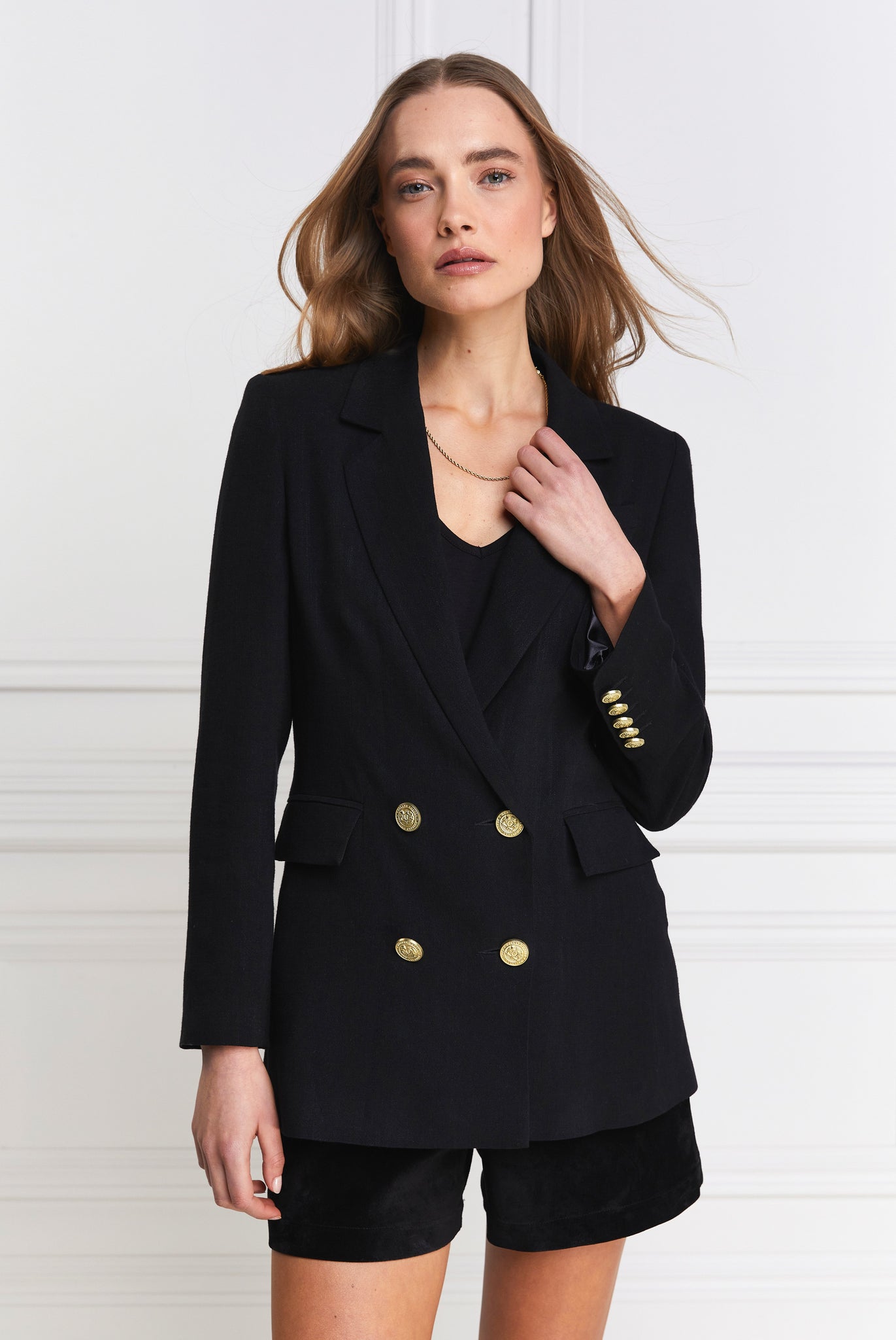 double breasted linen blazer in black with two hip pockets and gold button details down front and on cuffs and handmade in the uk
