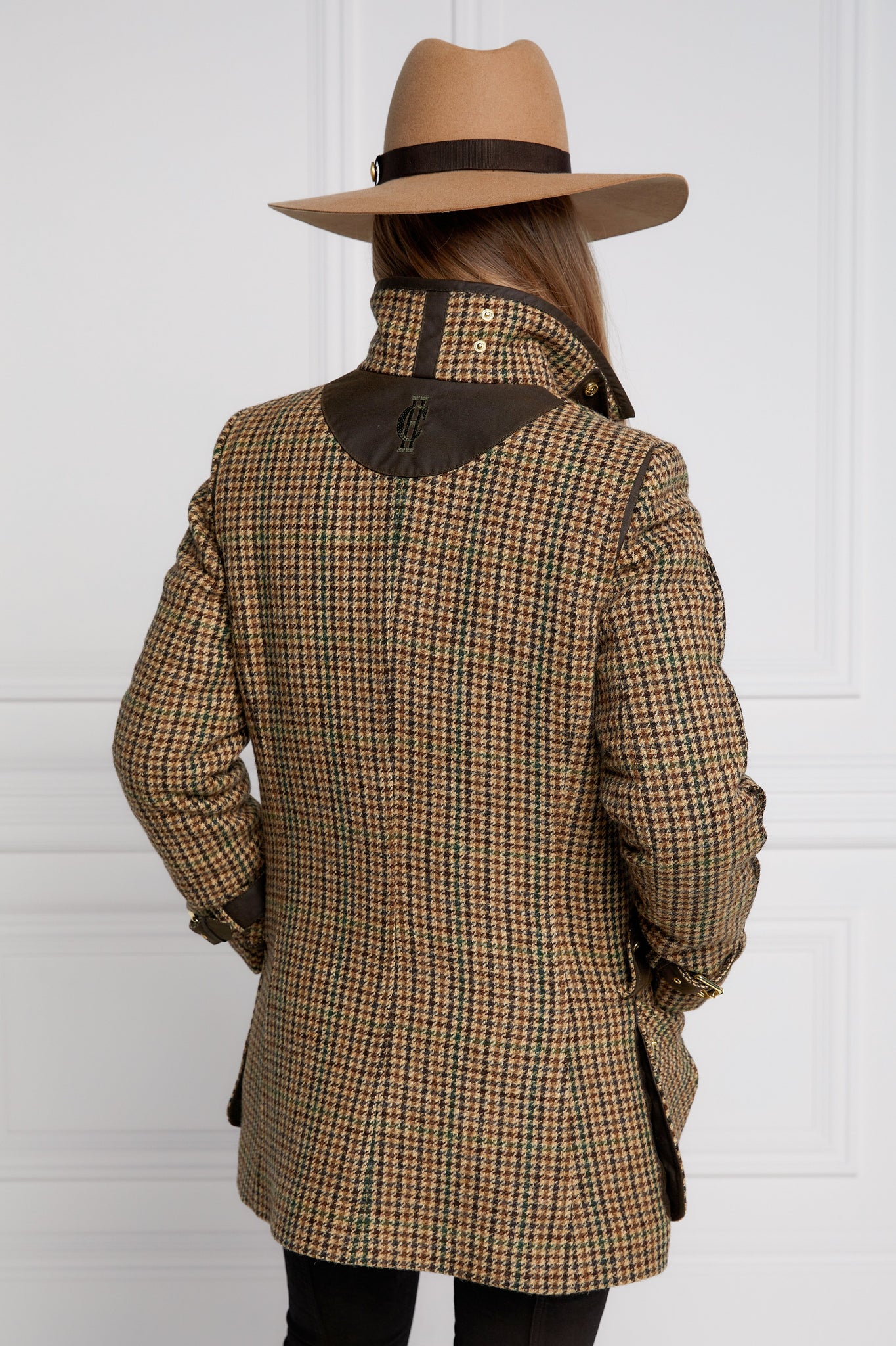Back of Woman in green and brown tweed field coat