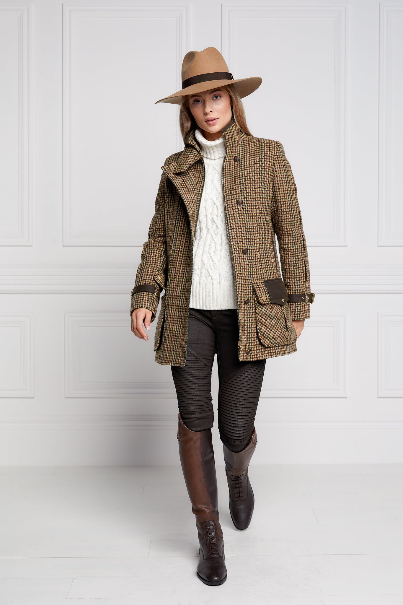 Woman in green and brown tweed field coat in brown trilby hat