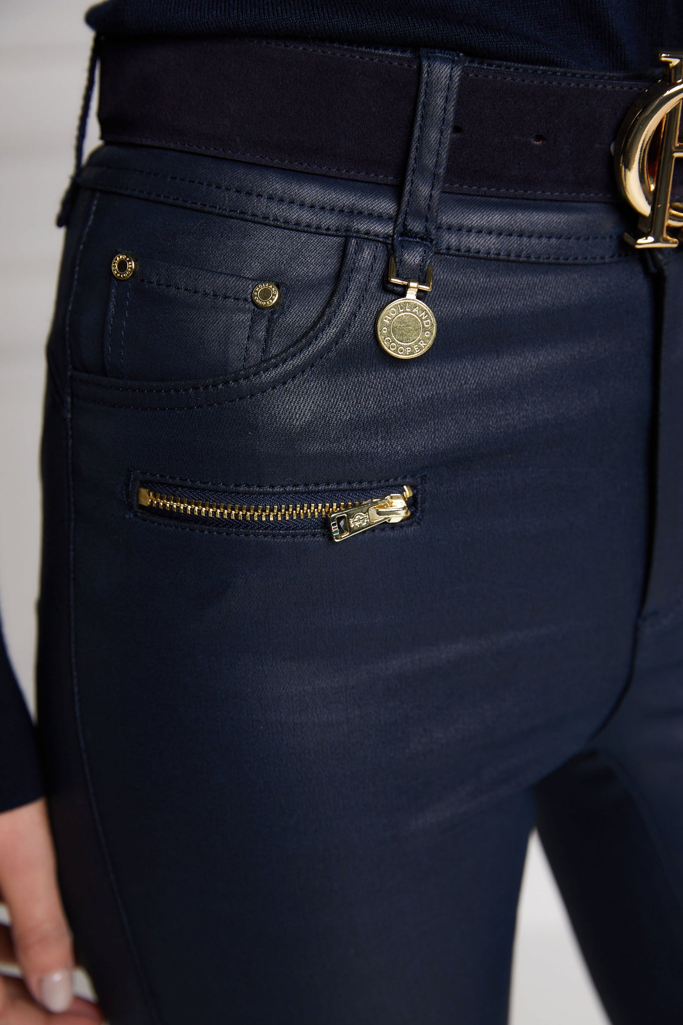front pocket detail on womens high rise blue coated skinny jean for a waxed look with jodhpur style seams with two open zip pockets to the front with HC branded pulls