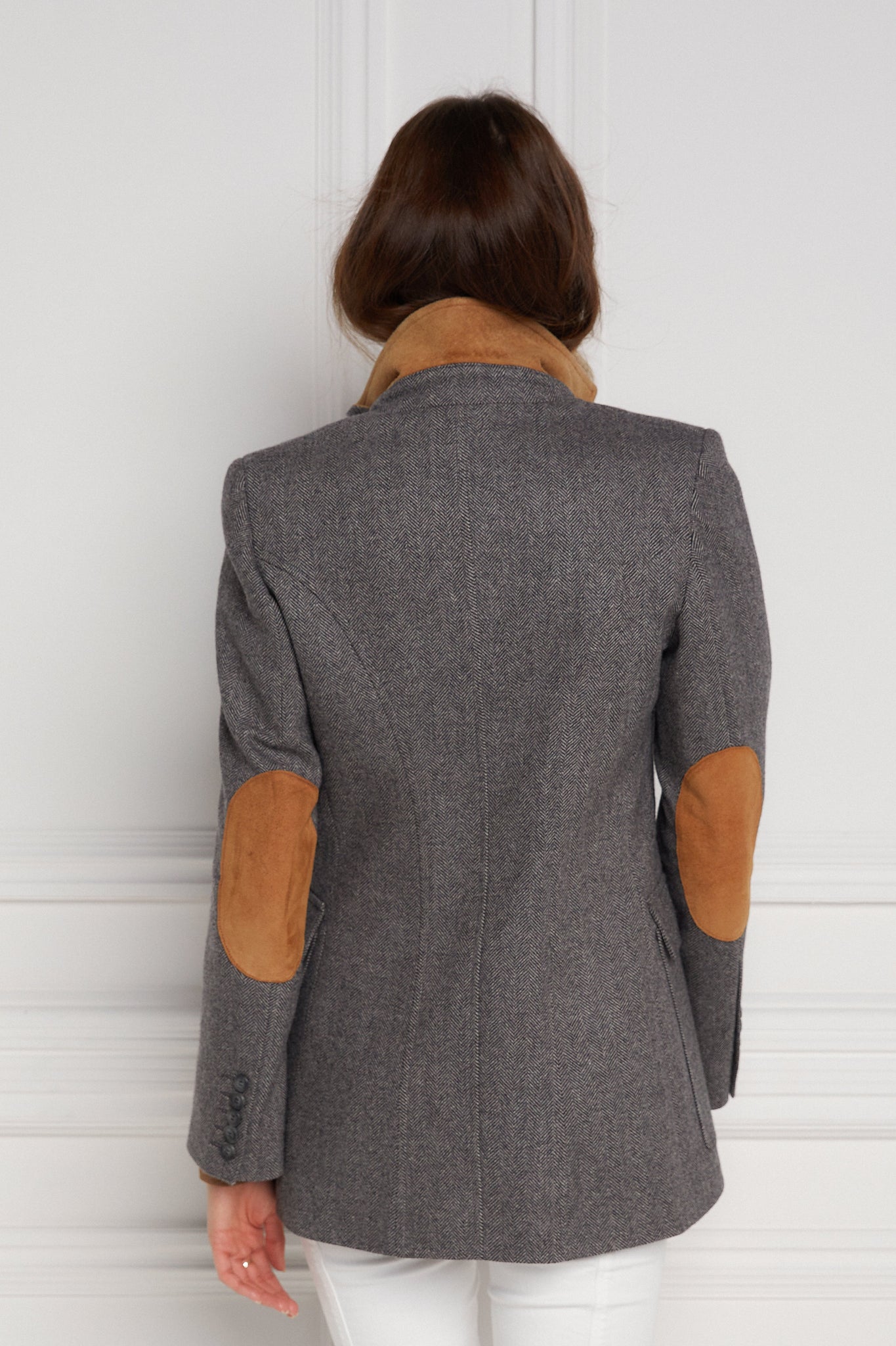 back of womens tailored fit single breasted blazer in grey herringbone with patch pockets and contrast tan suede elbow patches and underside collar