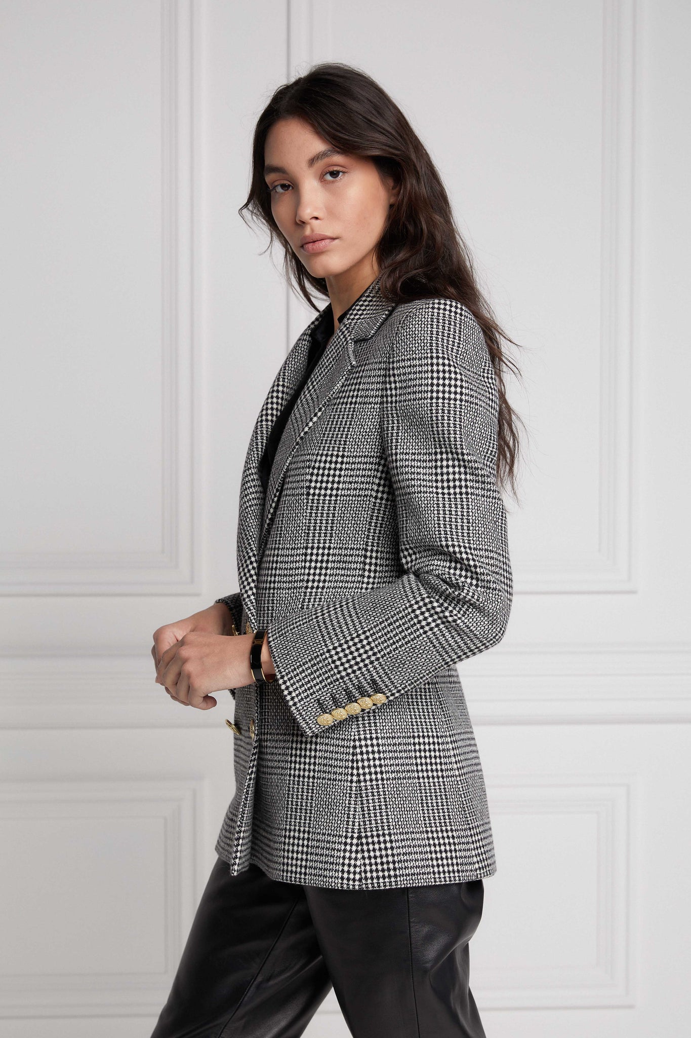 double breasted wool blazer in black and white check with two hip pockets and gold button details down front and on cuffs and handmade in the uk