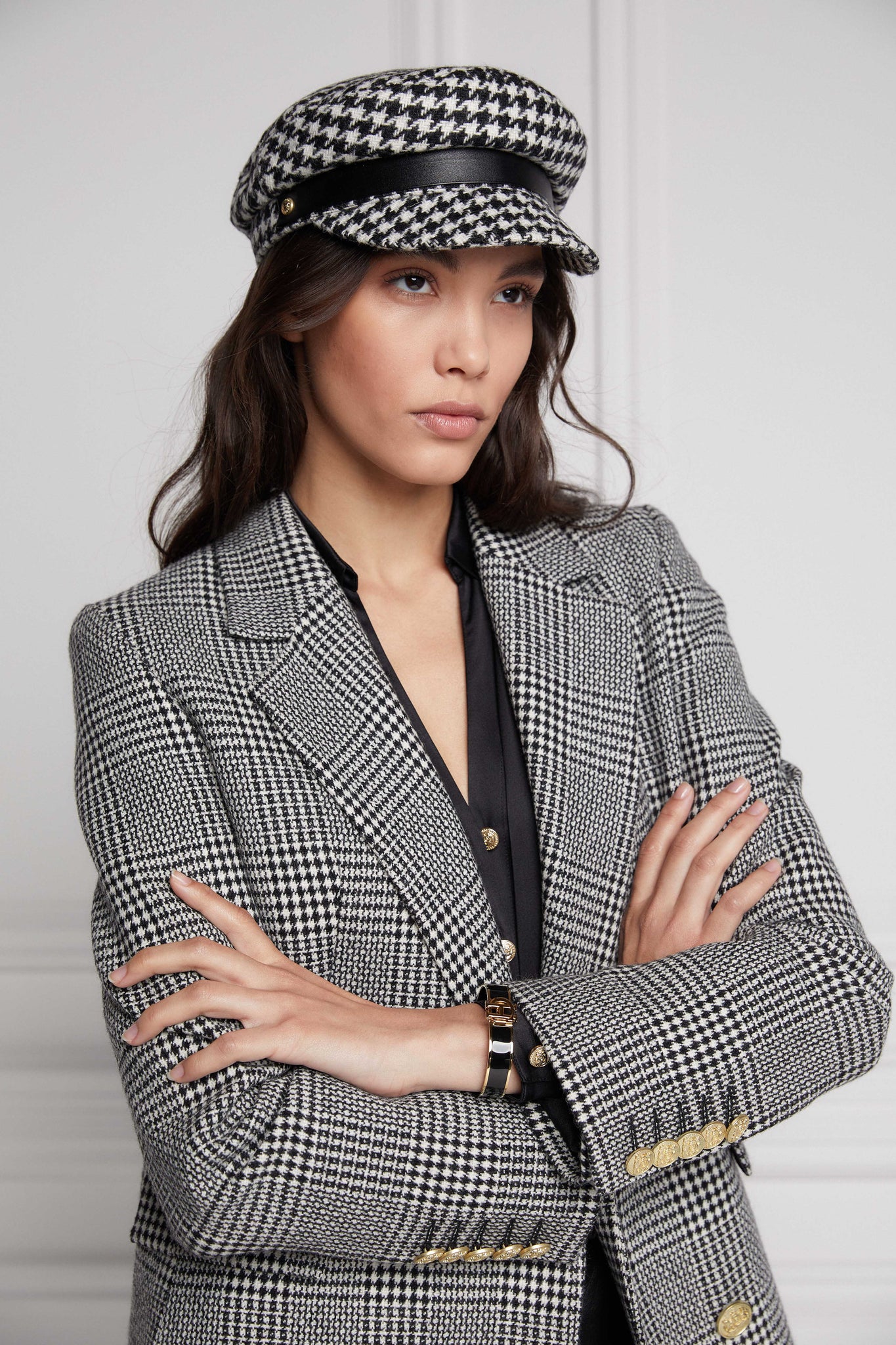 double breasted wool blazer in black and white check with two hip pockets and gold button details down front and on cuffs and handmade in the uk