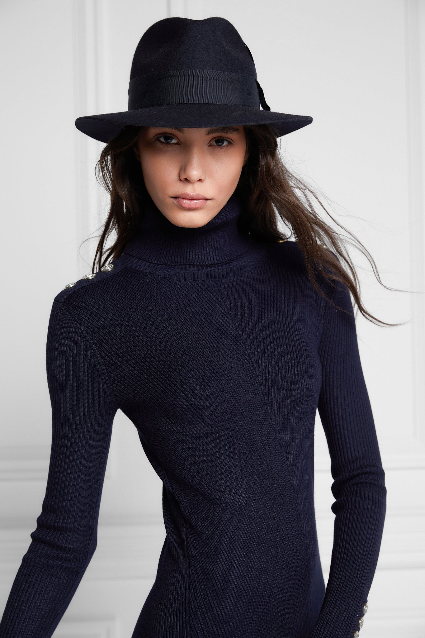 womens body-contouring navy knitted midi dress with ribbed roll neck and cuffs and gold buttons on shoulders and cuffs with navy fedora