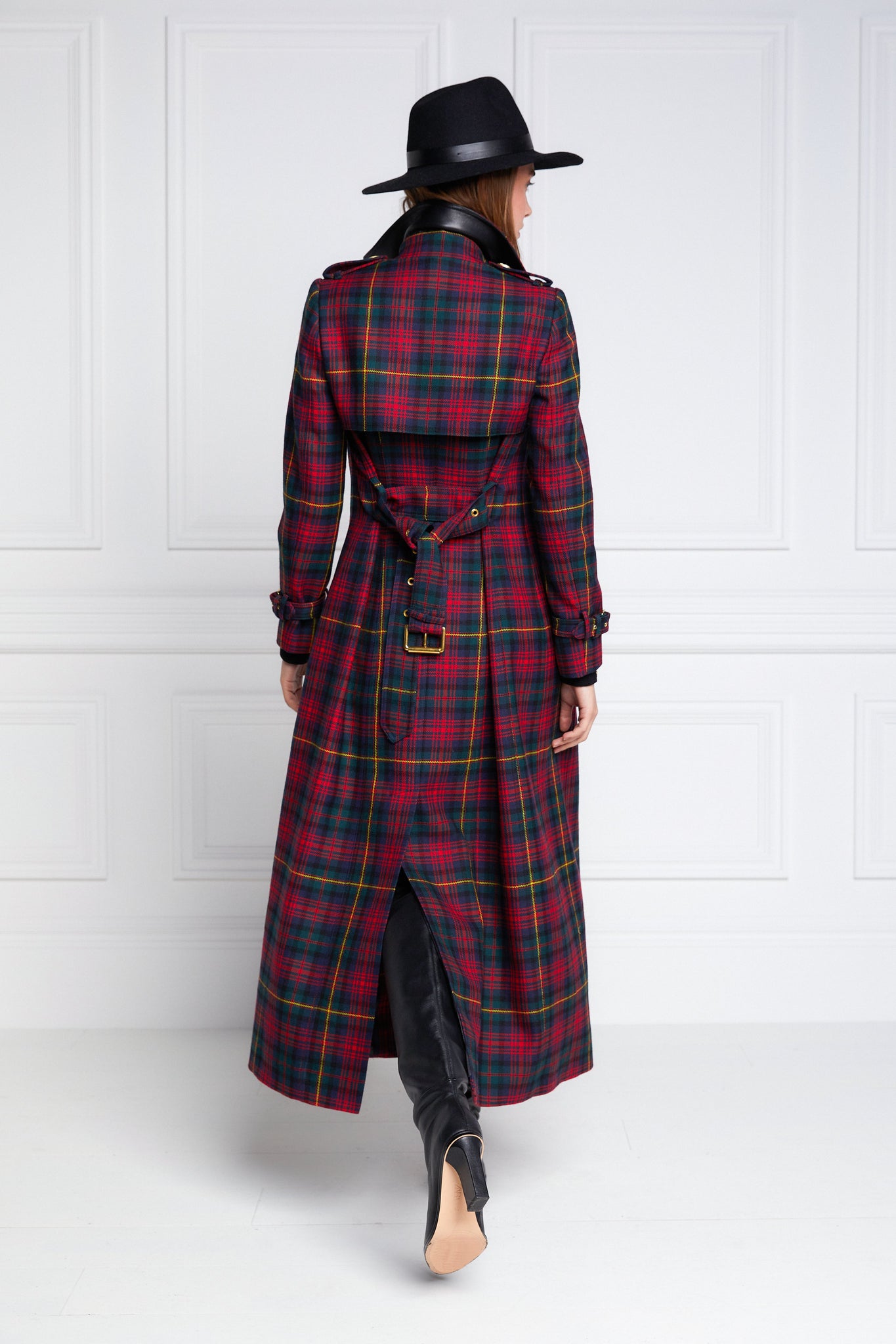 back of womens red and navy blue tartan double breasted full length wool trench coat with black trilby hat