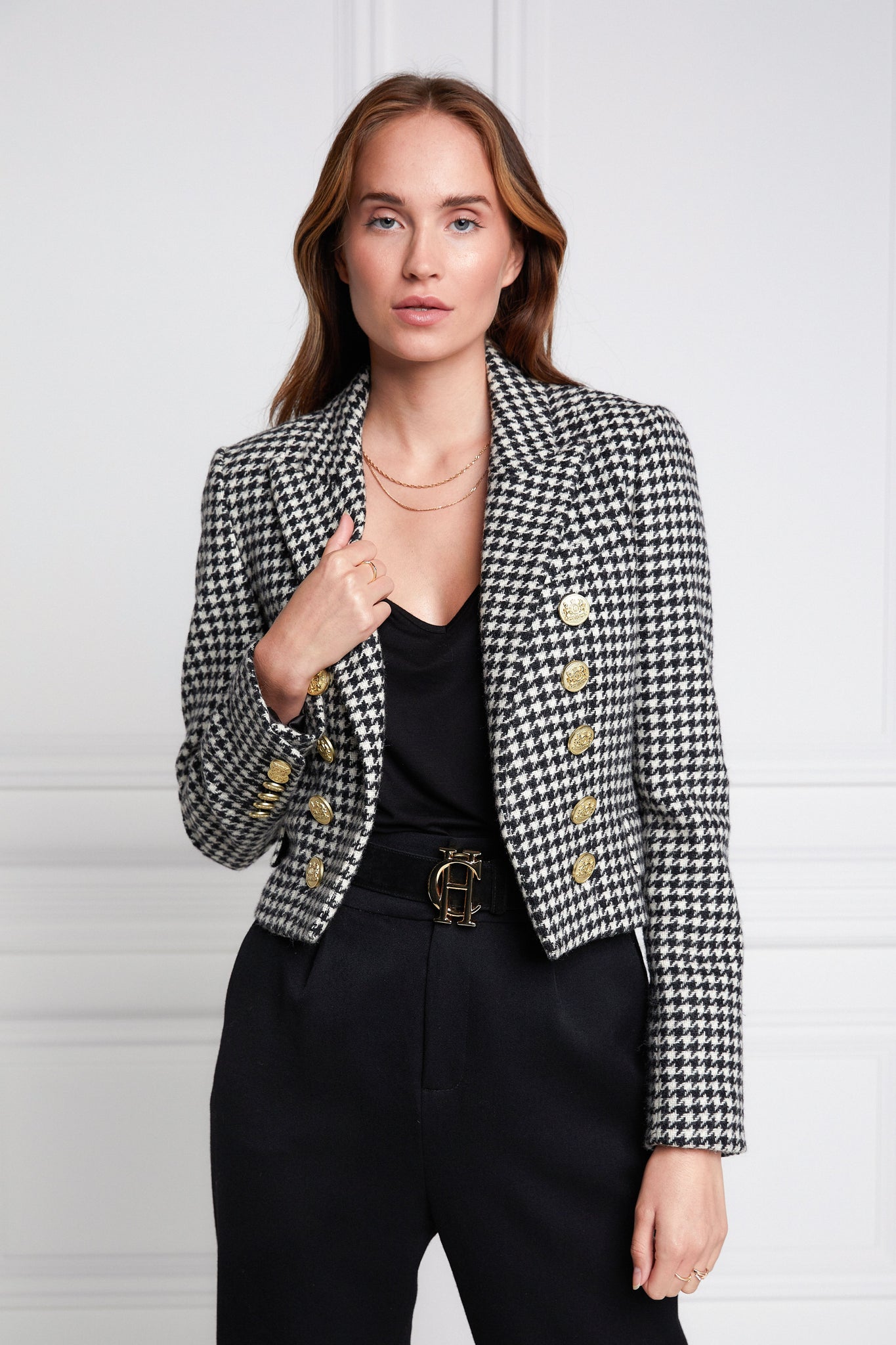 British made tailored cropped jacket in black and white houndstooth with welt pockets and gold button detail down the front and on sleeves