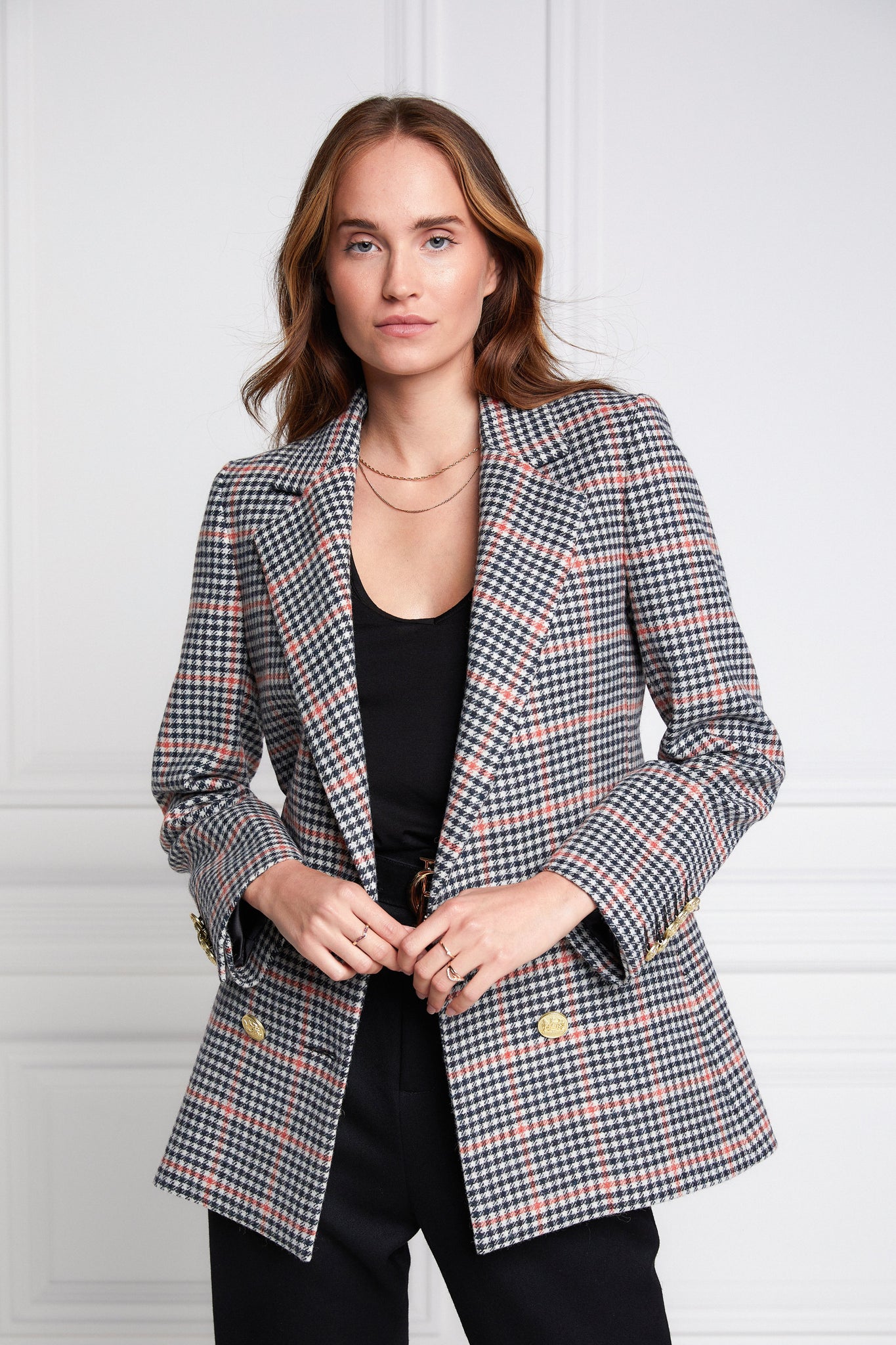 double breasted wool blazer in black white and pink check with two hip pockets and gold button details down front and on cuffs and handmade in the uk